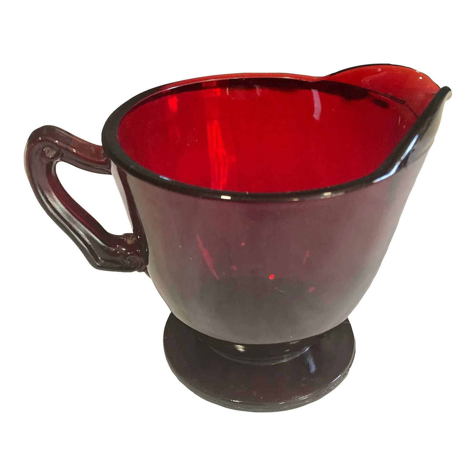 Mid-Century Ruby Red Glass Creamer: Add a pop of timeless color to your table with this vintage ruby red glass creamer. Crafted in a classic pedestal design with a graceful handle and pour spout, this piece captures the elegance and