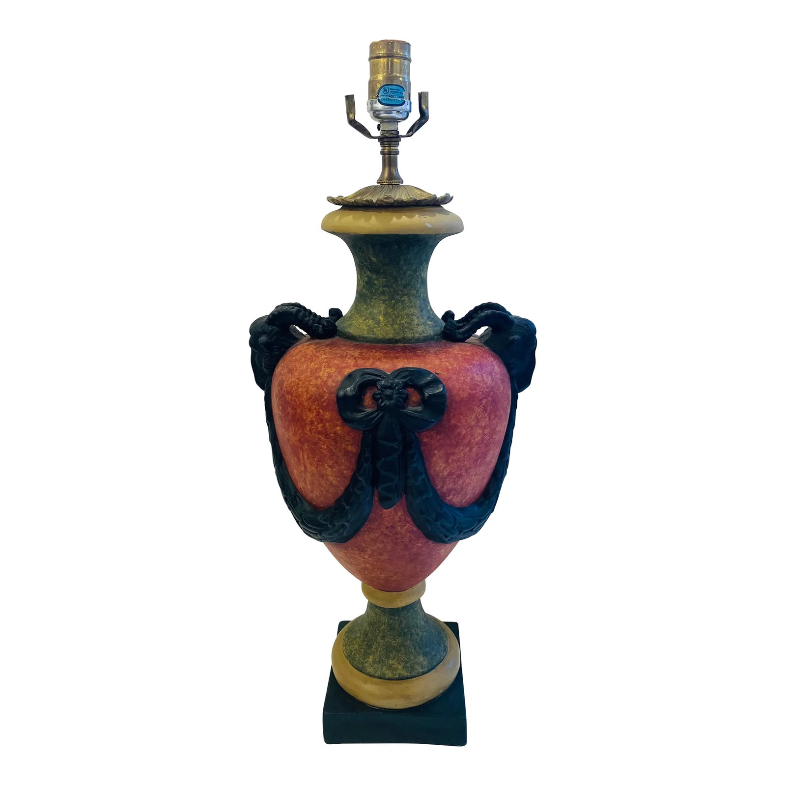 1980s Neoclassical Plaster Lamp: This cast plaster lamp has a faux stone finish. There is a terracotta red and pea soup green accented with swags and goat heads finished a dark bronze towards black Condition: Alterations: Original Co