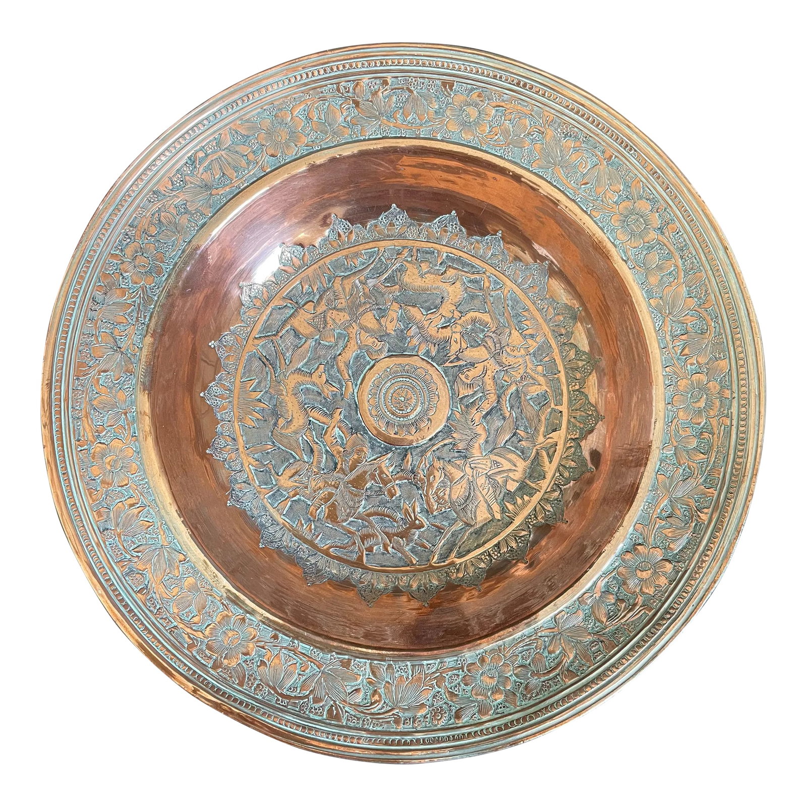 Antique Tinned Copper Moorish Repousse Plate With Persian Hunting Scene: Presenting an antique Persian tinned copper repousse plate. This exquisite piece showcases a hand-engraved hunting scene at its center, depicting huntsmen on horseback chasing deer (or gazelles) and