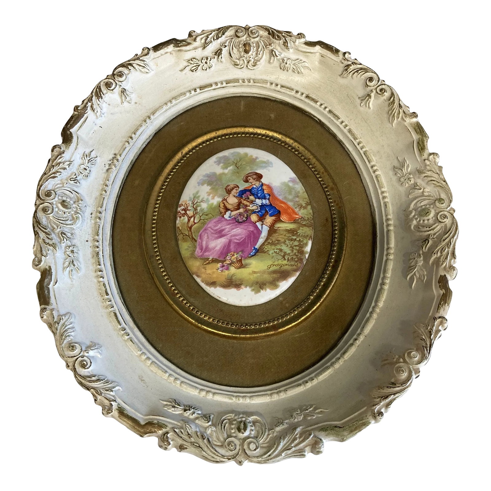 1930s B&s Creations Framed Victorian Courting Scene With Ornate Round Frame: This romantic framed porcelain plaque by B&S Creations features a hand-colored Victorian courting scene, beautifully rendered in delicate tones. The oval artwork is set within a richly ornate round