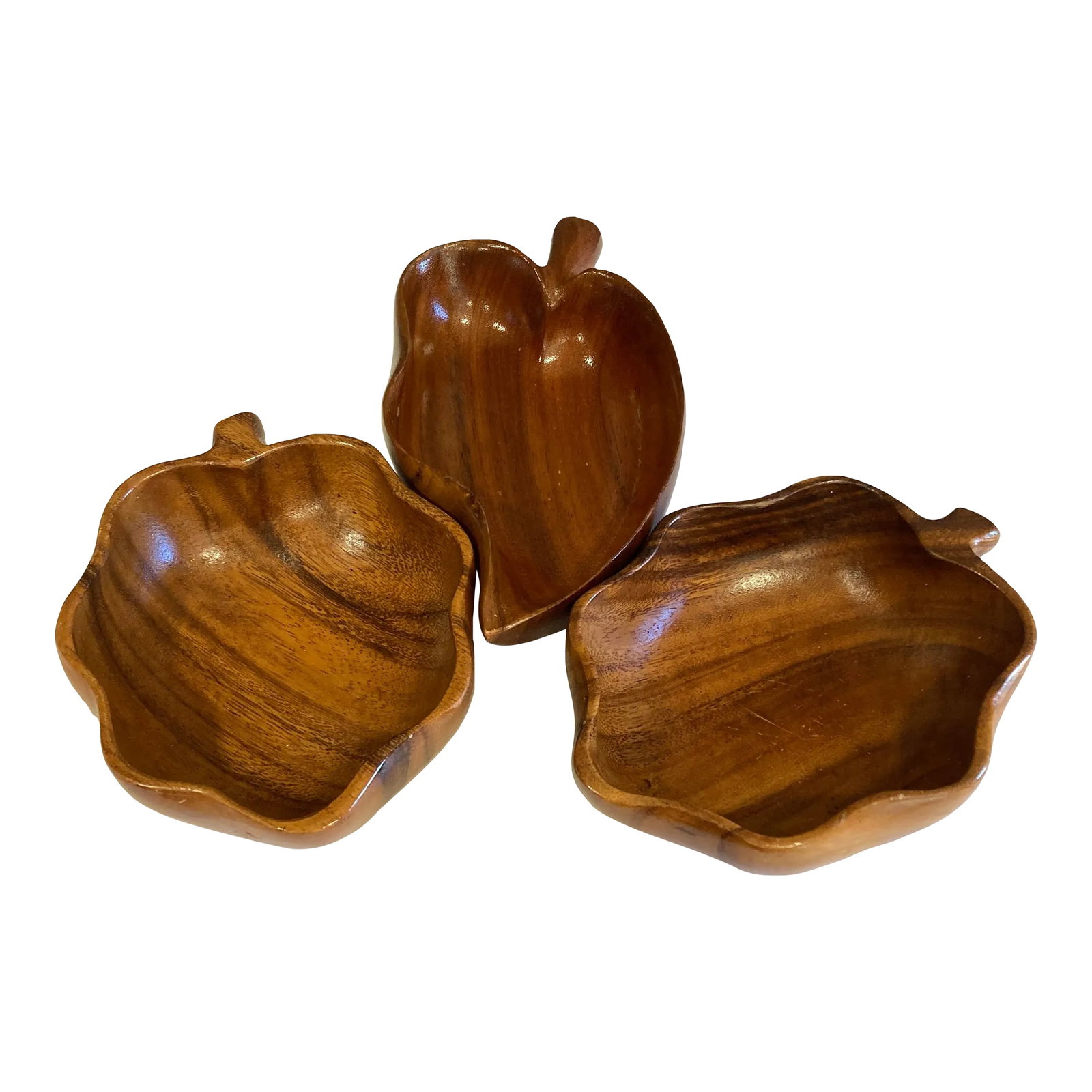 Vintage Monkey Pod Wood Leaf Serving Bowls - Set of 3: A beautiful set of three vintage monkey pod wood bowls featuring organic sculptural forms and richly figured grain. The collection includes three striking leaf-shaped bowls, each showcasing the warm
