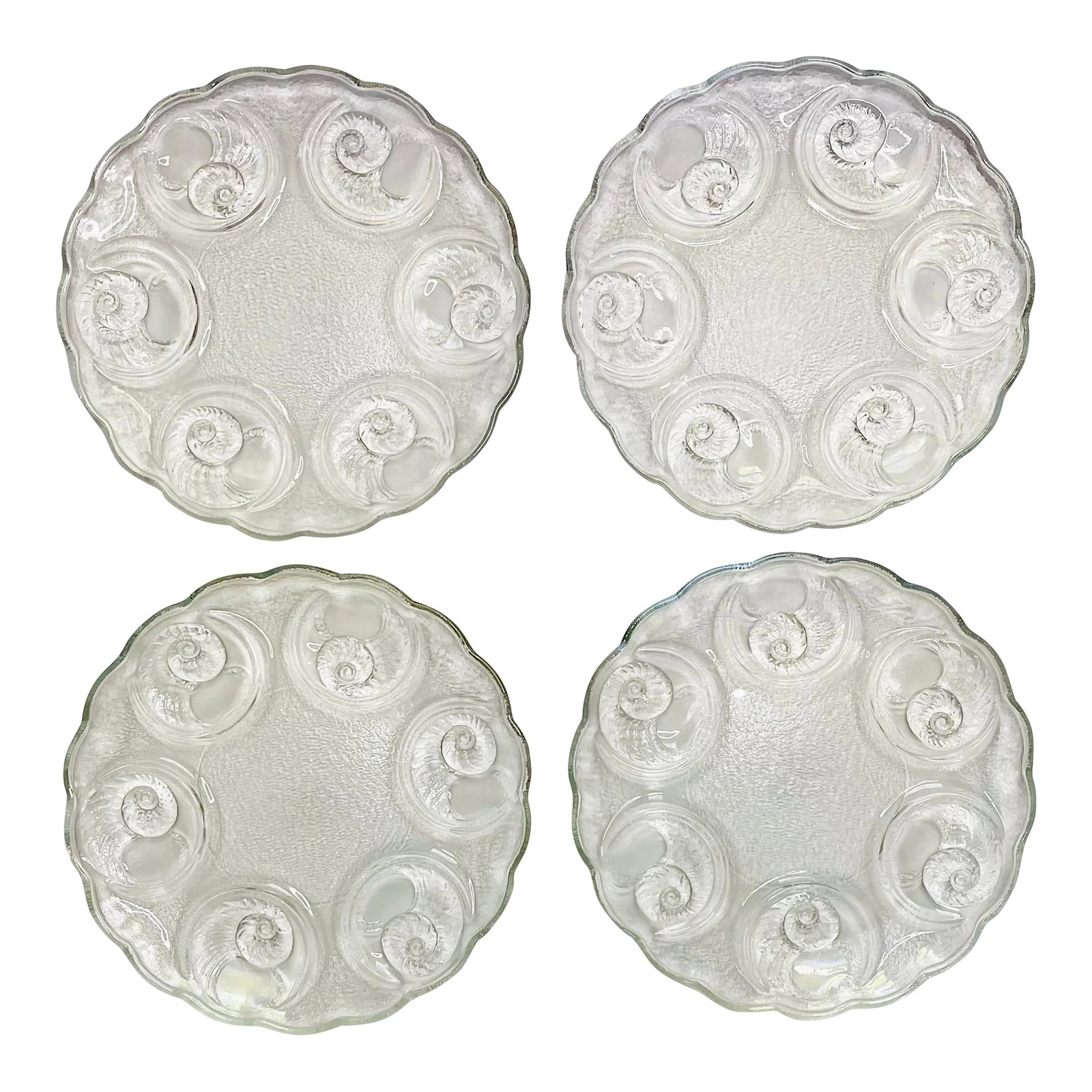 Vintage Spiral Shell Plates- Set of 4: Four textured clear glass plates with shell shaped indents suitable for oysters, escargot or other appetizers. Ships within 1-2 days using USPS. All items packed with care. Please contact us with any