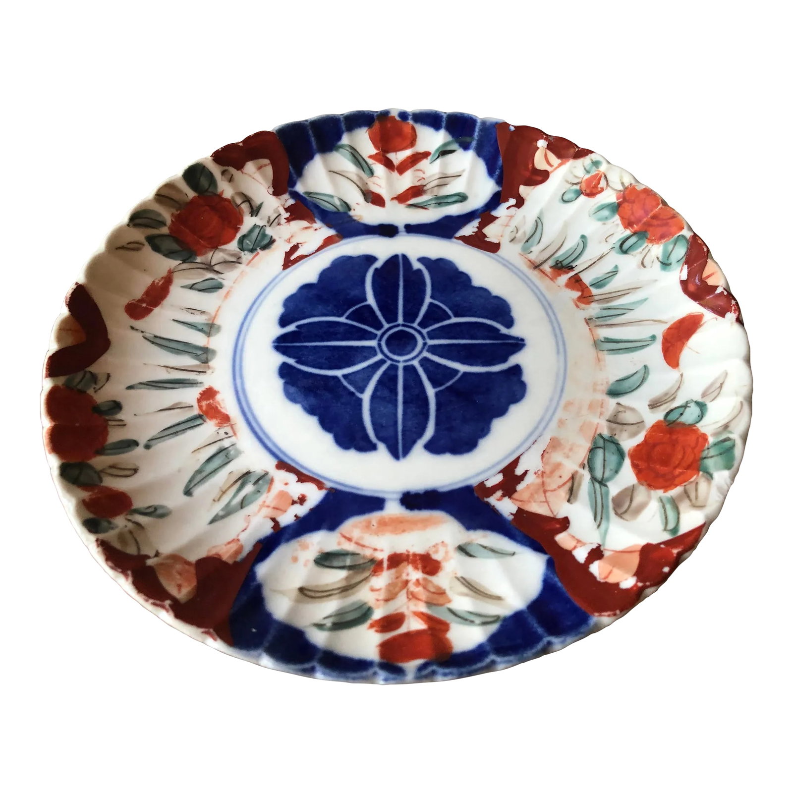 18th-19th Century Antique Japanese Imari Scalloped Rim Plate: Wonderful 18th to 19th century antique Imari plate with scalloped rim. Hand painted with central blue medallion, surrounded vibrant orange, crimson, blue, and green patterns. Bottom side has rim on ce