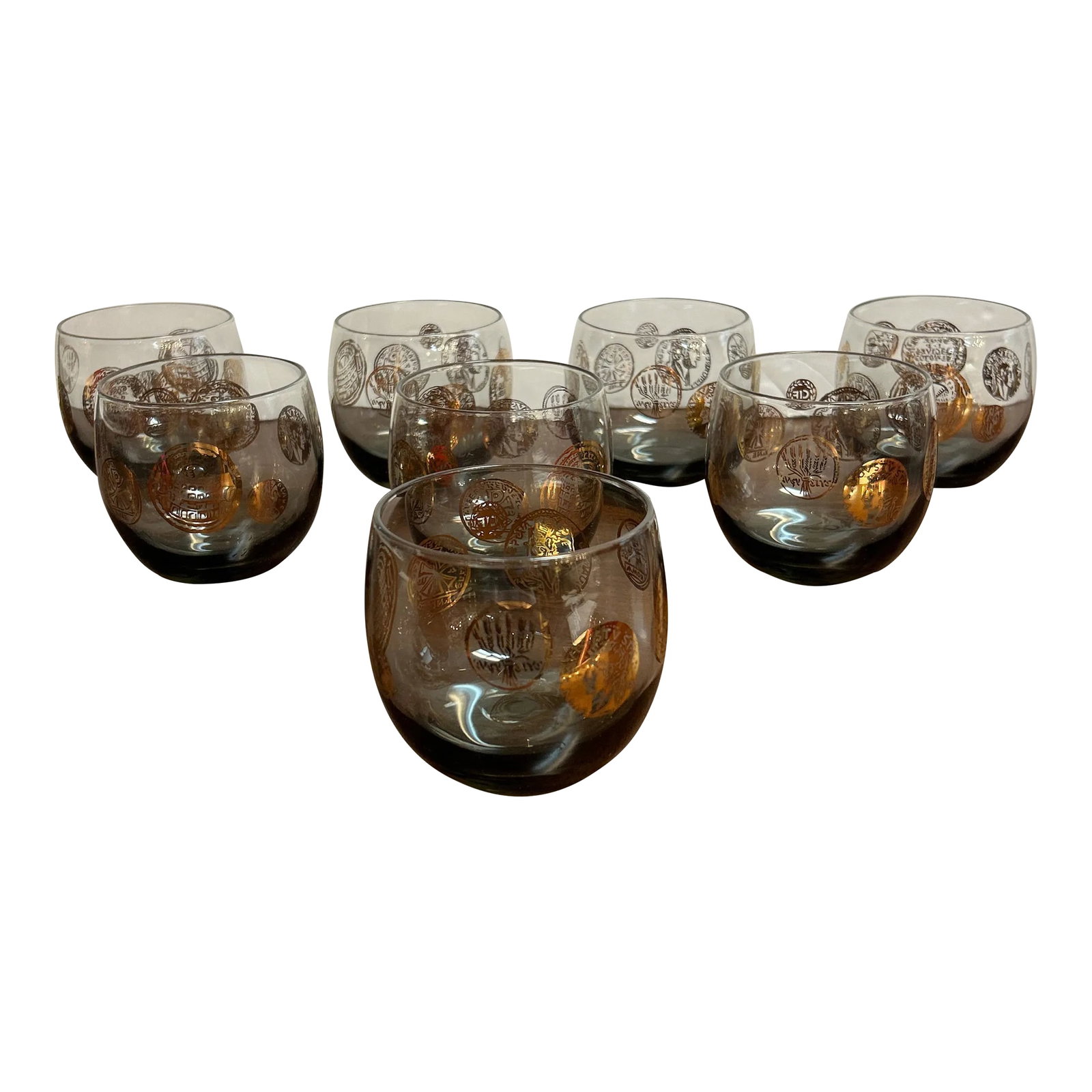 Vintage 1960s Rounded Lowball Cocktail Glasses With Painted Golden Motif Set of 8: Wonderful midcentury modern rounded lowball rocks glasses. The have a smoke green tint with handprinted gold medallions on them depicting coins from around the world. They're fun and practical all at
