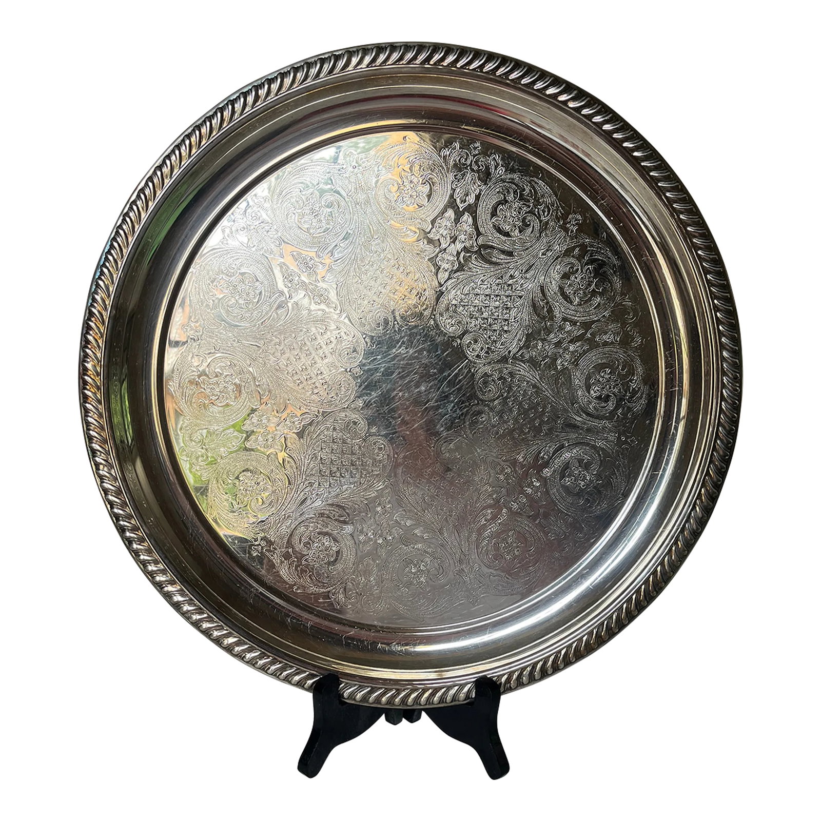 Silverplated Newport Gorham Round Tray: Classic silverplated round serving tray by Newport Gorham silver company. Round tray measuring 15.5." Floral and swirl engravings with an elegrant rope edge. Perfect for styling on a bar cart or coffe