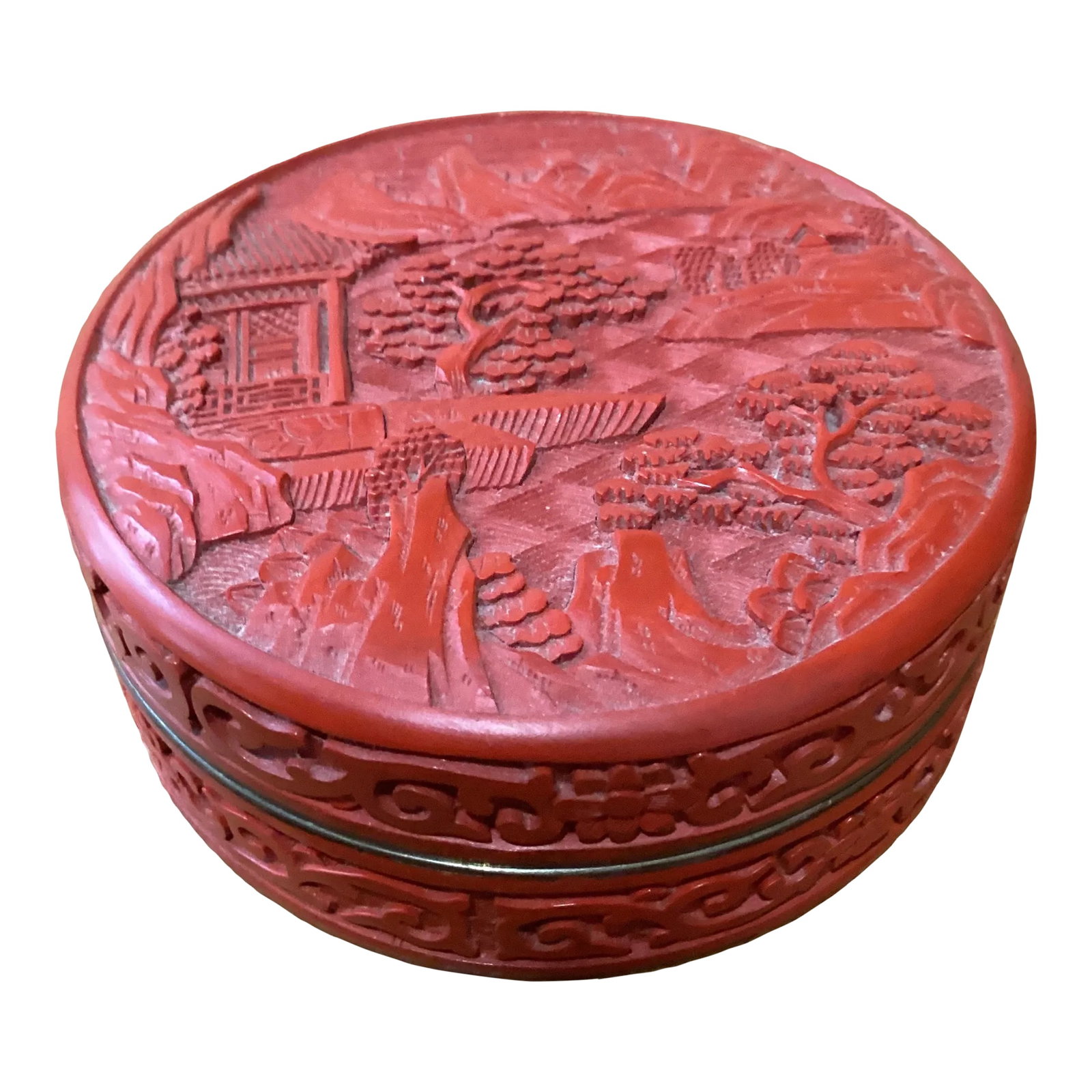 Late 19th Century Antique Small Carved Cinnabar Lacquer 'Scholar' Circular Box and Cover: Fine antique Chinese red cinnabar lacquer lidded rounded box carved with a rocky landscape with trees. The "dragon's blood" box has a fine design around the sides with a royal blue lacquered