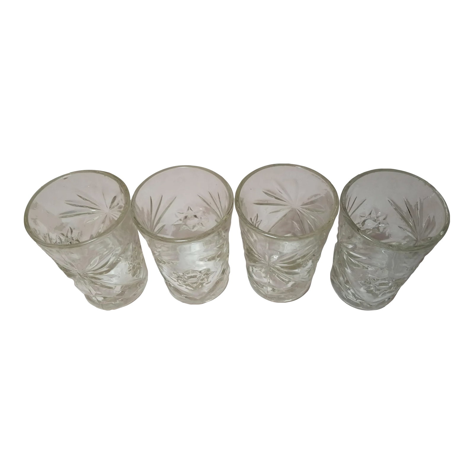1960s Anchor Hocking Prescut Juice Glasses - Set of 4: Four vintage Anchor Hocking Juice Glasses. They have the classic starbursts and star of David patterns. These were made in the 1960s. Excellent shape! Each glass measures 4 1/2" tall and 3" in