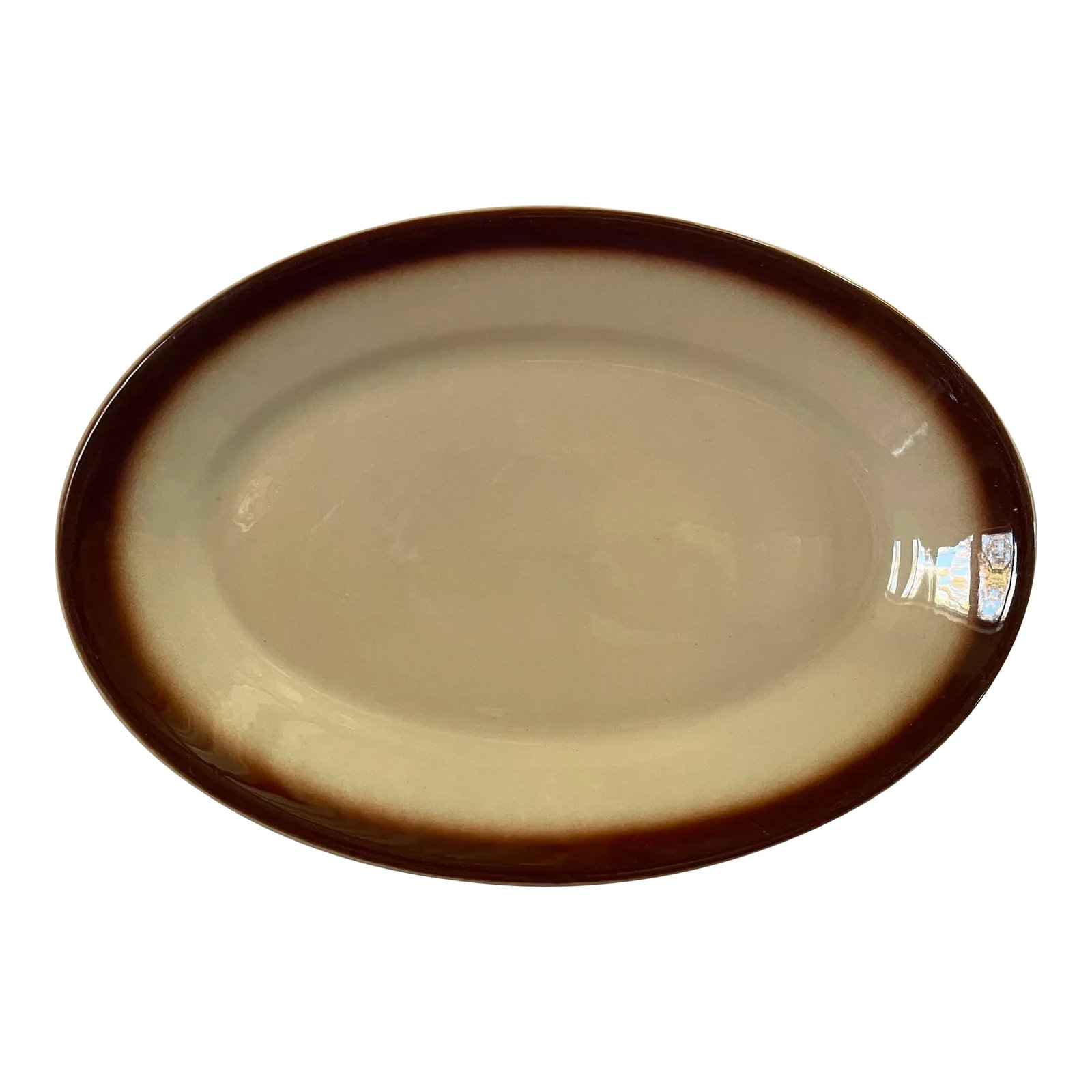 Mid 20th Century Wellsville China Tan and Brown Platter: A classically simple oval china platter which is light tan edged with a deep brown border made in Wellsville, Ohio during the mid 20th century. -Platter measures 14 inches long by 9 1/2 inches wide.