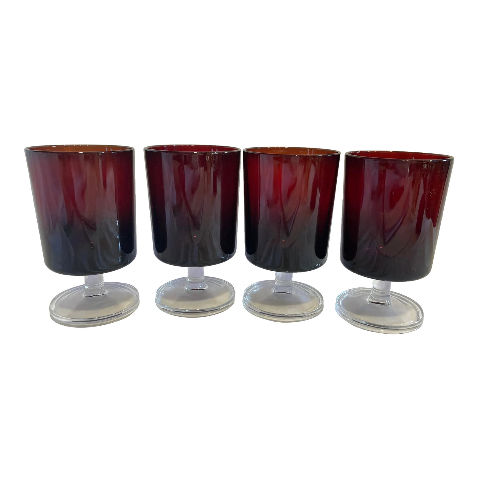 Mid-Century French Ruby Red Footed Glasses With Transparent Stems- Set of 4: Beautiful set of 4 glasses by Arcoroc France. These are a lovely ruby red color with transparent stems. Condition: Alterations: Original Condition Unaltered Imperfections: Some Imperfections Condition