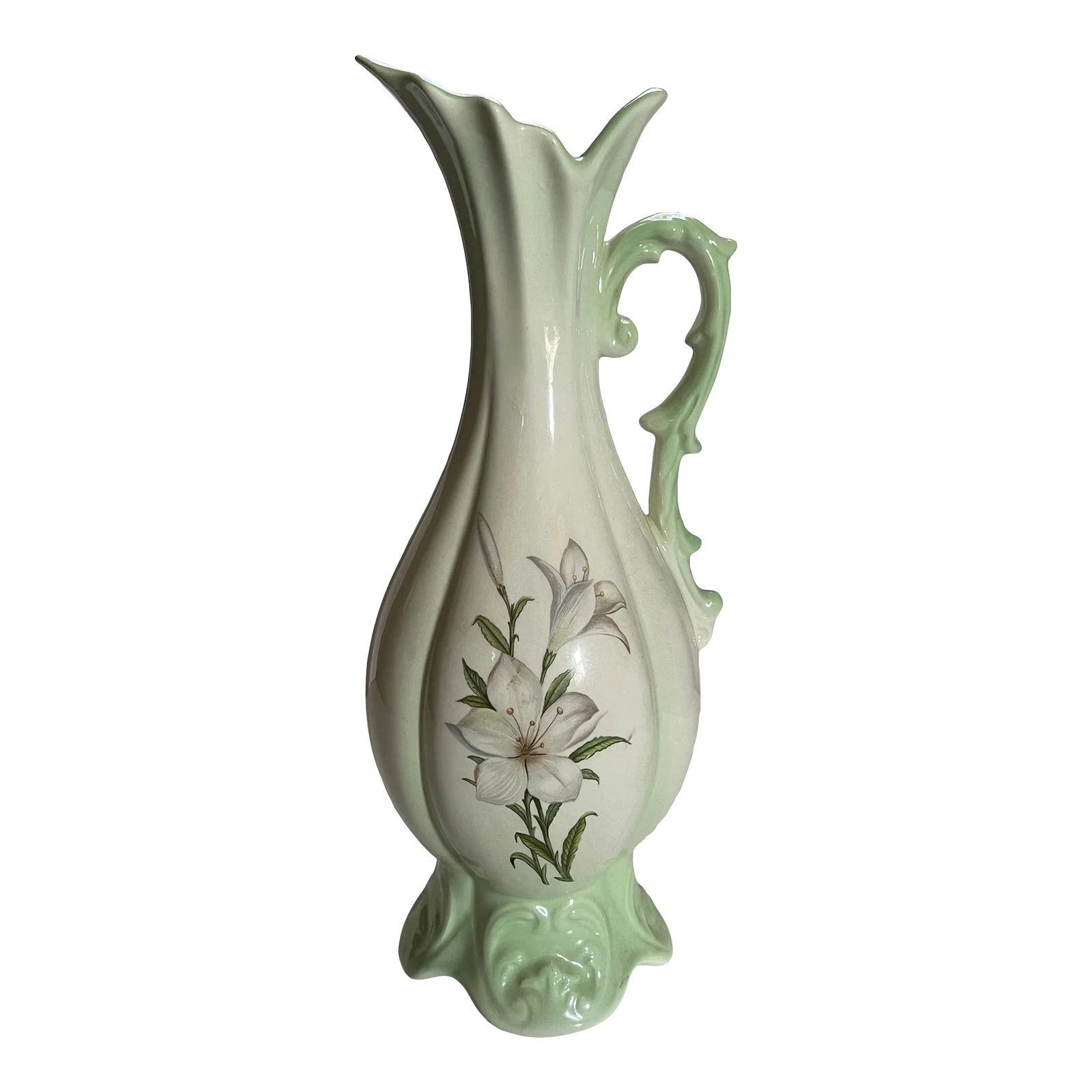 Mid 20th Century Pale Green Lily Decorative Jar: A striking 20th century fluted decorative pitcher/vase in shades of green with an illustration of lilies in bloom. Ships within 1-2 days using USPS. All items packed with care. Please contact us with 