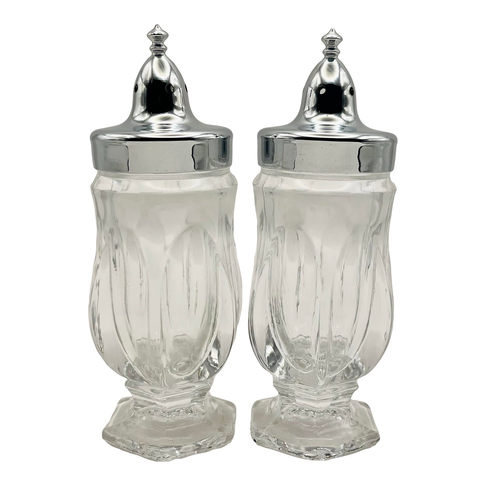 Vintage Pressed Glass Salt & Pepper Shakers- a Pair: A pair of vintage clear glass salt and pepper shakers on an octagonal foot and capped with a silver colored shaker top. Ships within 1-2 days using USPS. All items packed with care. Please contact us