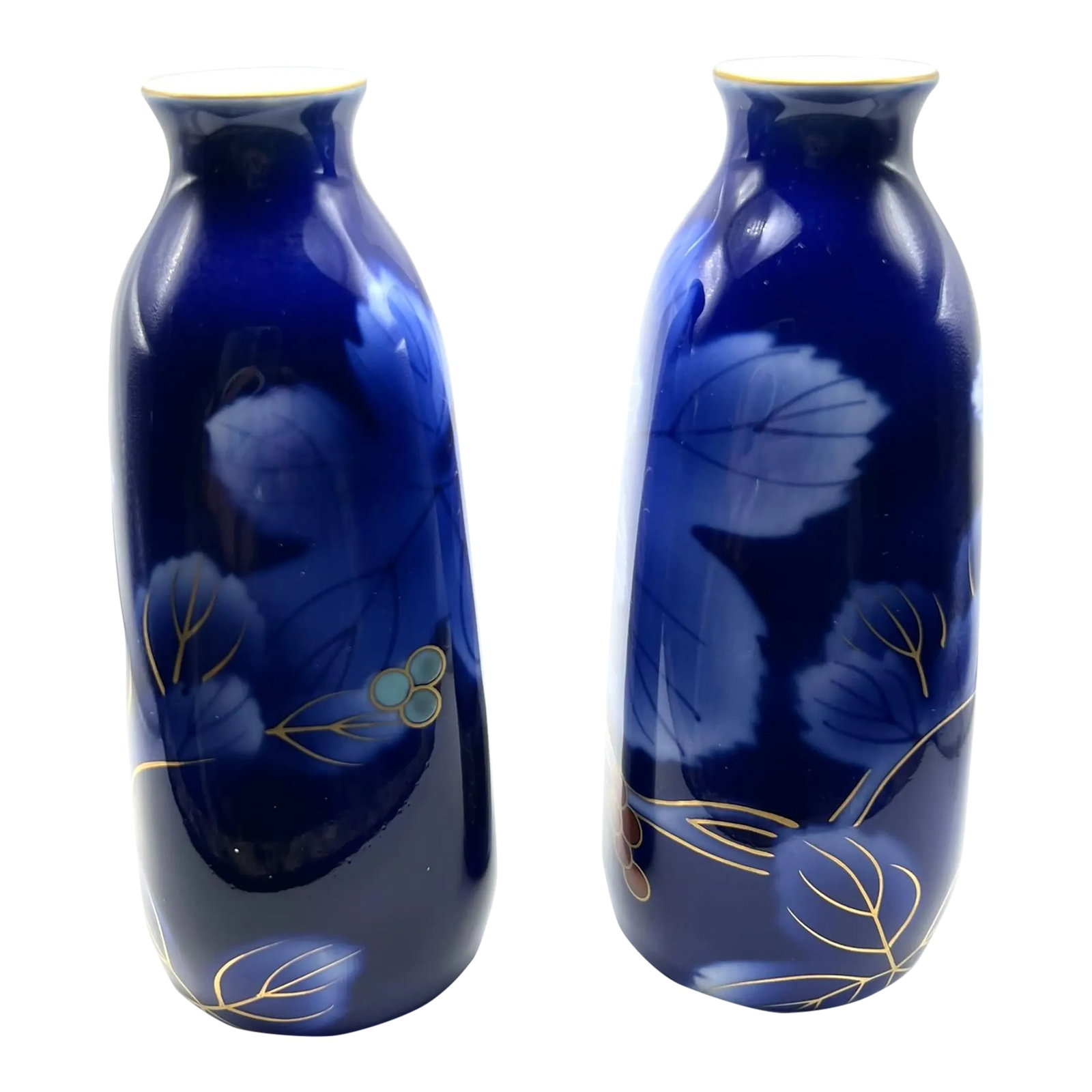 Fukagawa Seijji Cobalt Blue Sake Bottles: The beautiful and rich cobalt blue glaze is a signature glaze of the Fukagawa factory. Decorated on each bottle over the deep rich cobalt blue glaze are lighter blue leaves with veins in a deeper