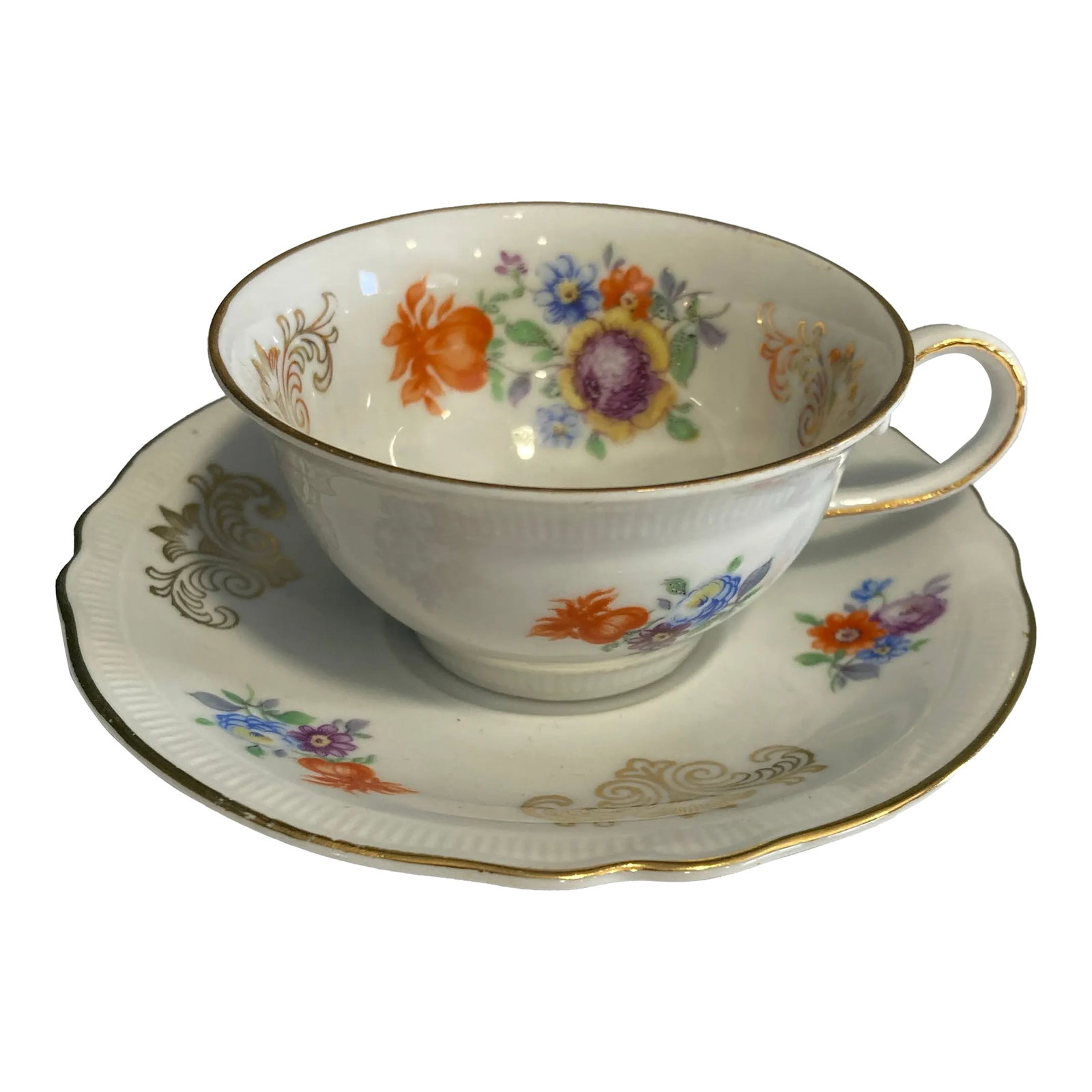 Vintage Schumann Bavaria Floral Demitasse Cup and Saucer: Very beautiful painted orange, blue and yellow flowers. Gilt edging and painted gold scrollwork. Made in US Zone Germany Condition: Alterations: Original Condition Unaltered Imperfections: Some Imperf