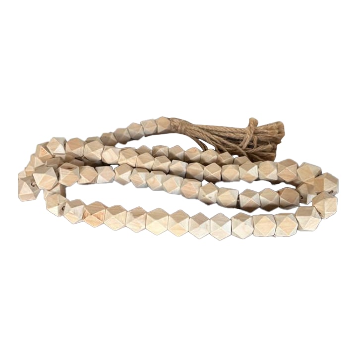Wooden Bead Garland: This beautifully hand-crafted strand of wooden beads brings a rustic elegance to any space. Each bead is meticulously shaped into a geometric form, showcasing the natural grain and warm tone of the