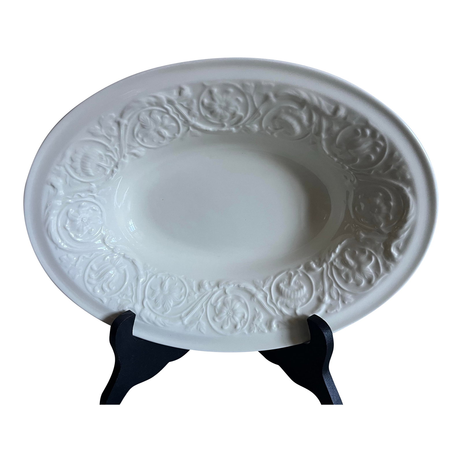 1980s Wedgwood of Etruria & Baralaston Patrician Oval Serving Bowl: Bone China. Ivory, creamy off white, raised, embossed design around rim consisting of scrolls of flowers, leaves and vines. Condition: Alterations: Original Condition Unaltered Imperfections: Some