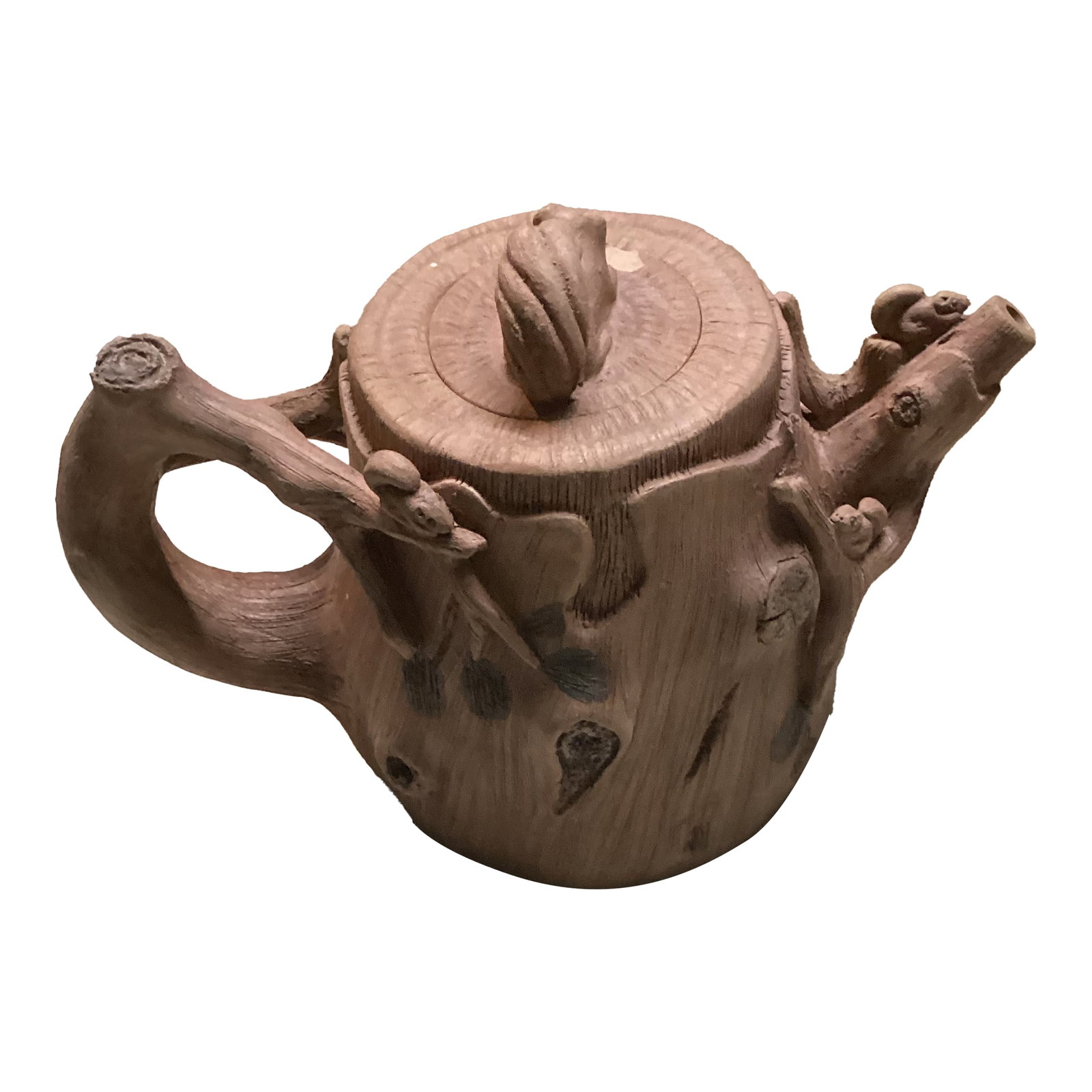 1970s Squirrel and Tree Trunk Tea Pot Yixing Style: This is a very rare, unusual teapot. The natural earthy tones and intricate carvings give it a one-of-a-kind look that's perfect for collectors and the tea enthusiasts alike. It adds a touch of