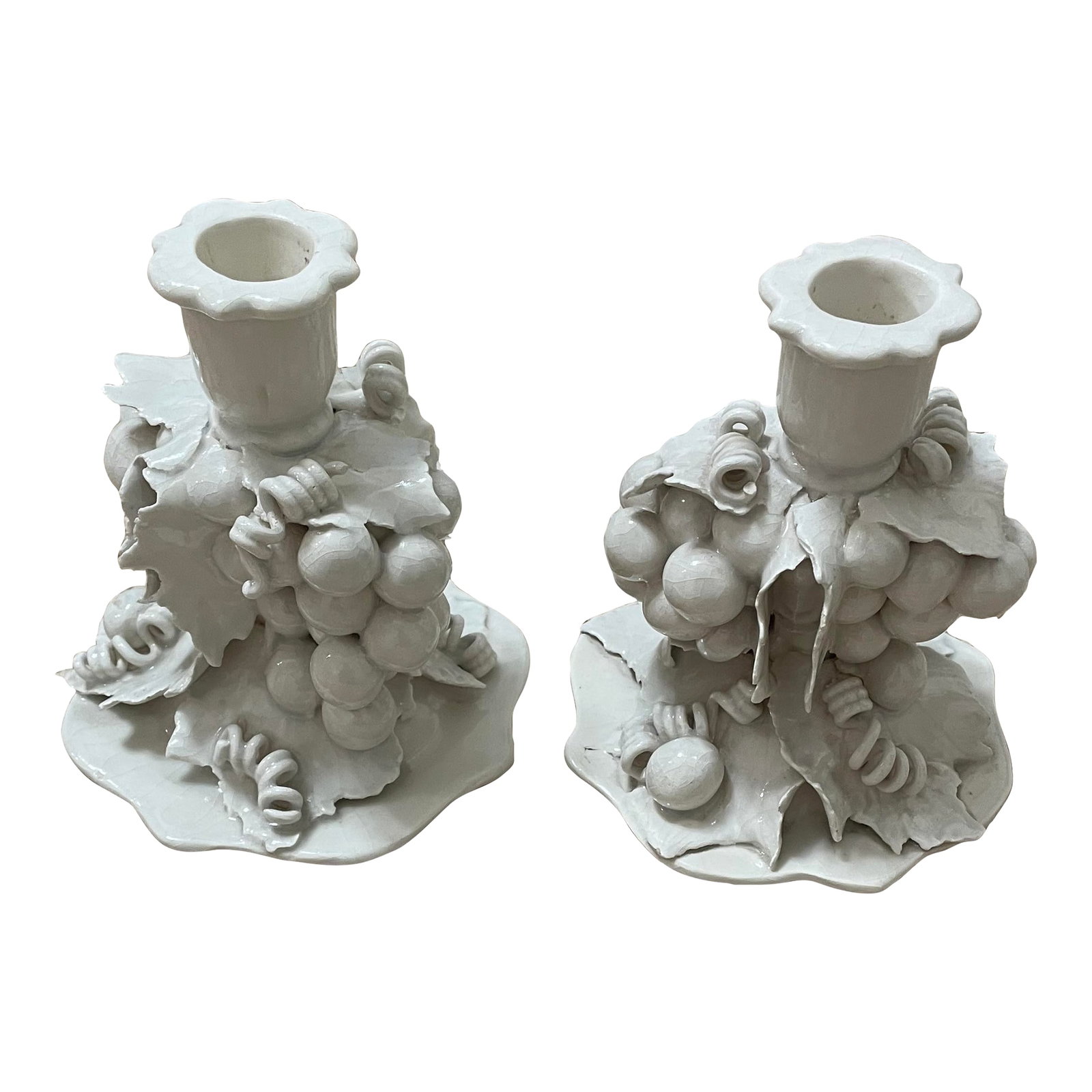 Pair of 1960s Porcelain White Indicate Grapevine Candlesticks: This product is a pair of vintage porcelain white candle holders in the shape of grapevines. The elegant design and high-quality material make them a stylish and durable addition to any home decor.
