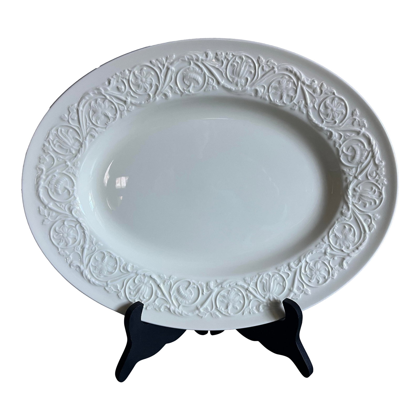 1980s Wedgwood of Etruria & Barlaston Patrician Serving Platter: 14" by 11 34" by 1 1/4"; Bone China; Ivory, Creamy White; Raised, Embossed Design around Rim, consisting of Scrolls of Flowers, Leaves, and Vines. Condition: Alterations: Original Condition Unaltered