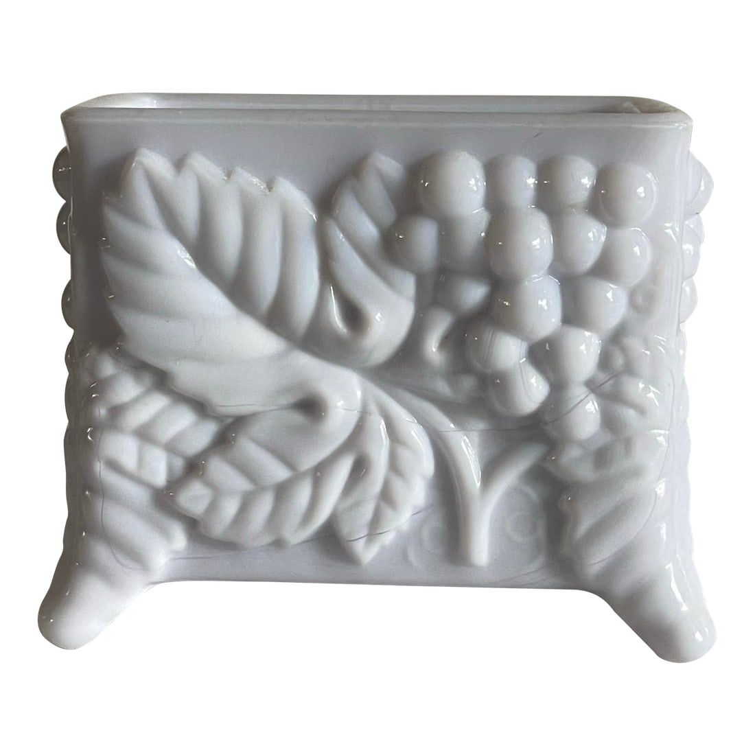 Mid 20th Century Grape Glass Card Holder: A vintage glass footed tabletop card/ toothpick holder decorated with bunches of grapes amid textured leaves. This piece is made from slag glass as can be seen from the veining which is visible in