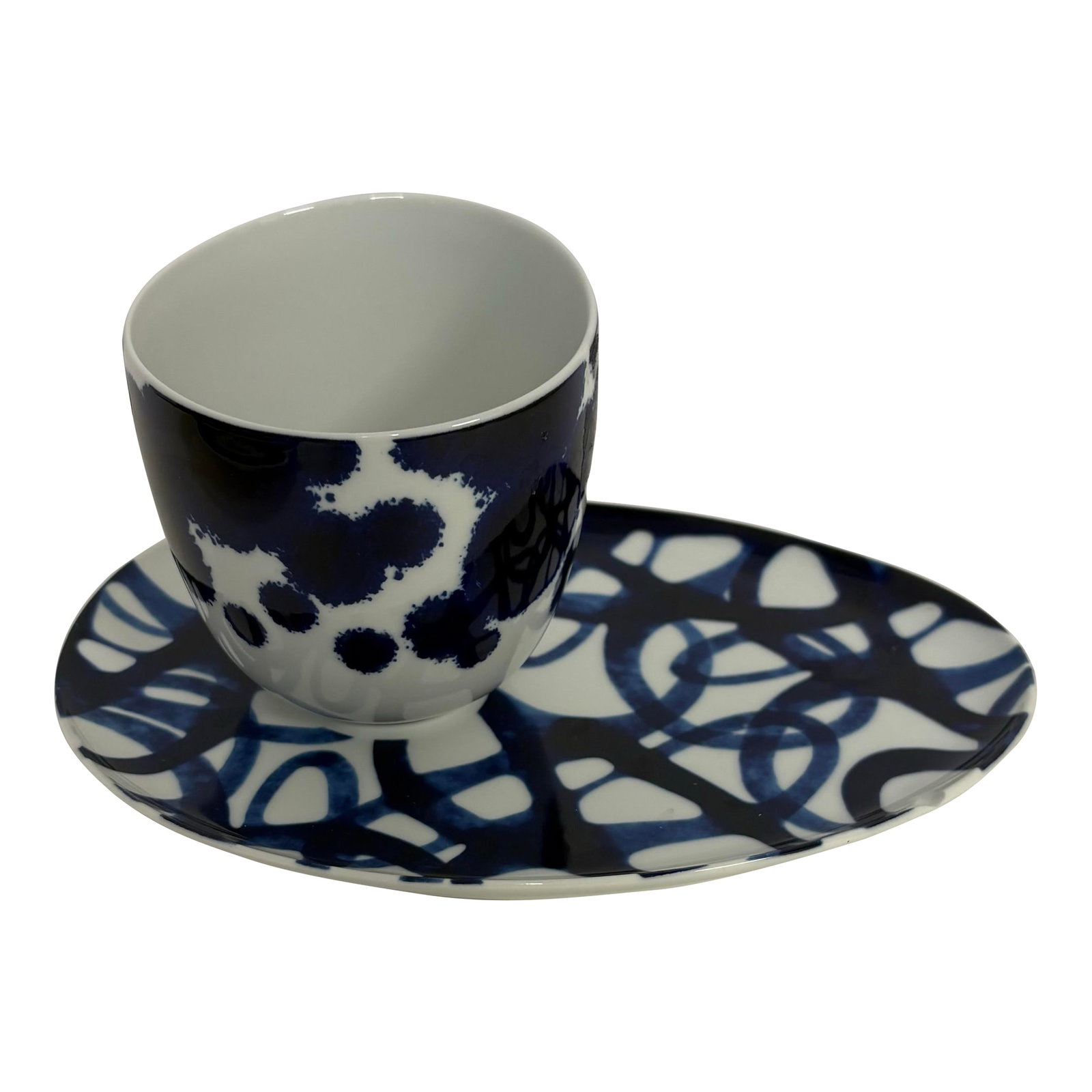 1990s Como by Paola Navone for Crate & Barrel Asymmetrical Cup and Saucer Set: Single cup and saucer that in the Como pattern by Paola Navone for crate and barrel done in an asymmetrical design in a beautiful cobalt blue and white swirl pattern ** there are two small chips in