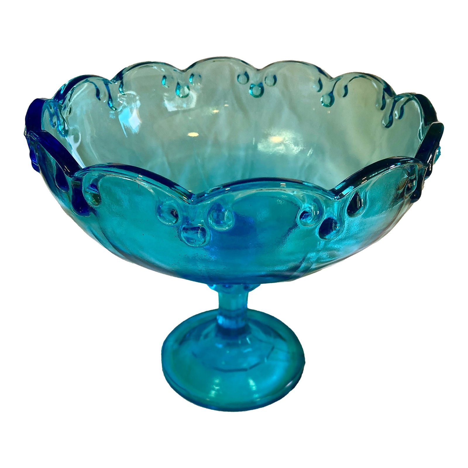 Vintage Aqua Blue Glass Compote With Scalloped Edge & Bubble Motif: This stunning vintage aqua blue glass compote features a scalloped rim and raised bubble details that give it a dynamic and decorative presence. The pedestal form adds height and elegance, making it