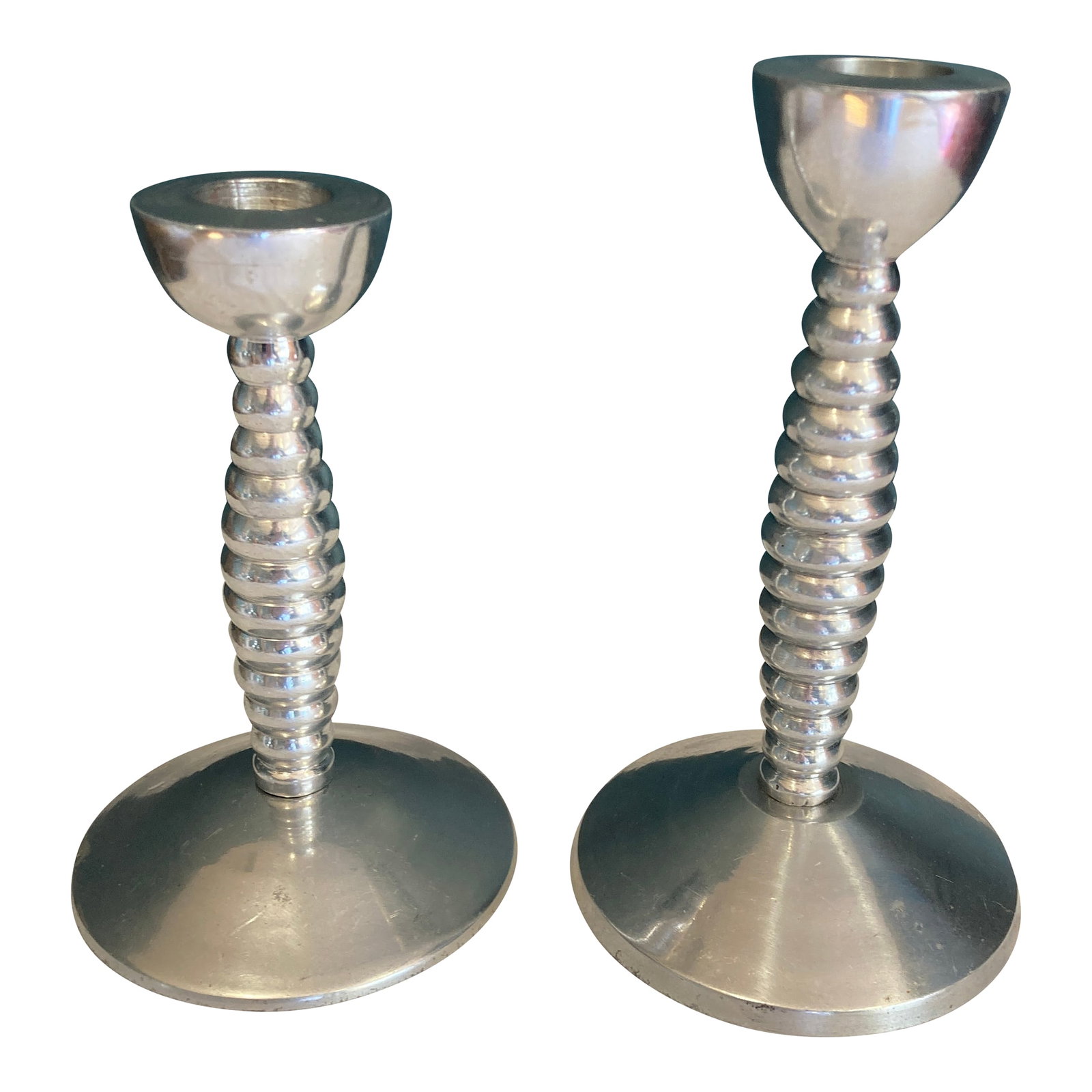 Mid-Century Modern Candlesticks - Stacked Ring Design Pair: An exceptional pair among our vintage finds, these Metalworks by International candlesticks exemplify the sculptural minimalism of mid-century modern design. The distinctive stacked ring construction 