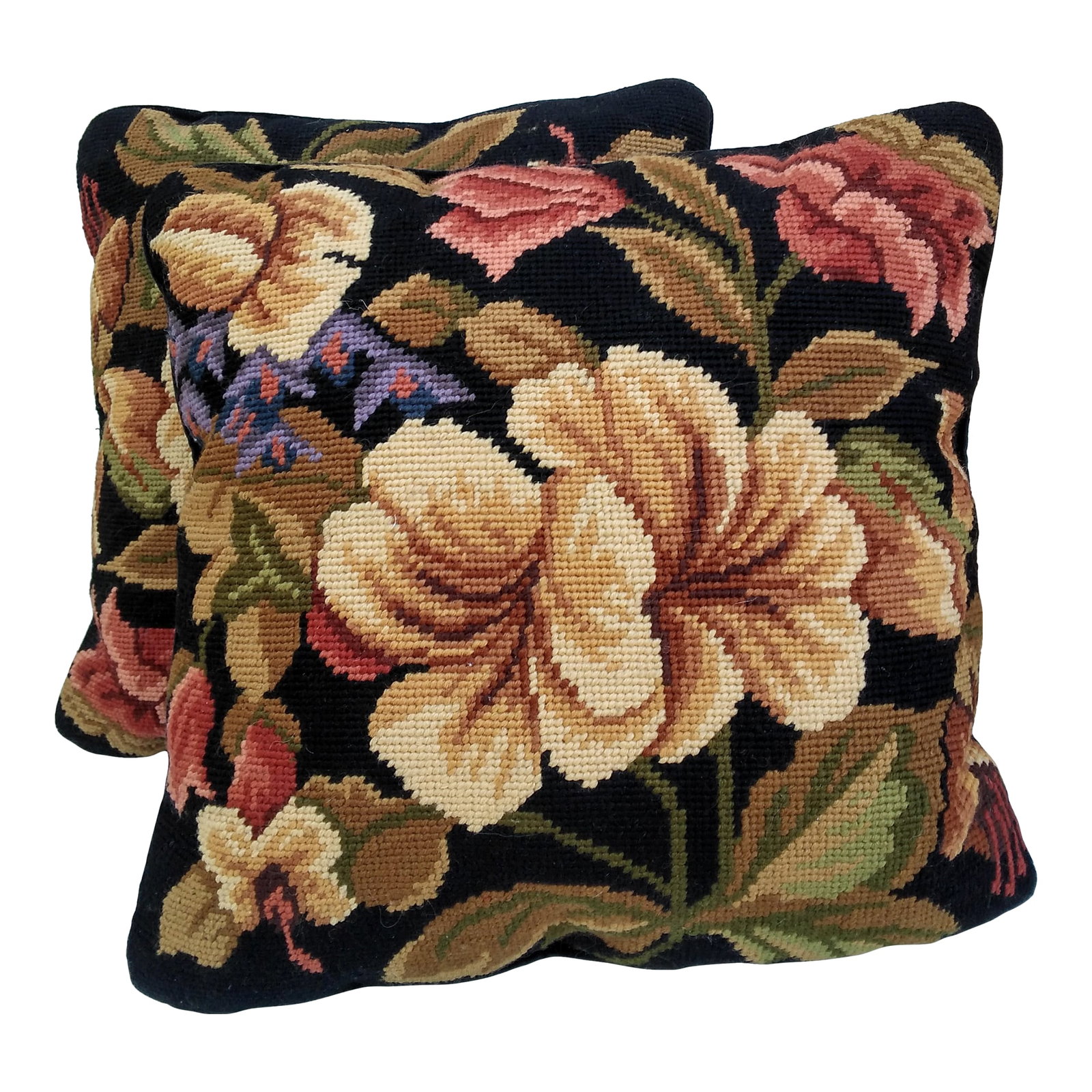 Pair of Vintage Floral Needlepoint Pillows: This pair of early 21st Century needlepoint pillows features a floral design of fall colors on a black background. These pillows are about 20-25 years old, and they are in excellent vintage condition