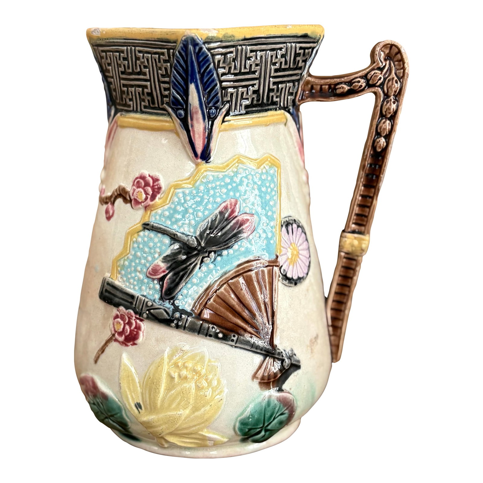 Victorian Majolica Aesthetic Movement Pitcher - Japonisme Lotus, Fans & Dragonfly, c.1880: A striking Victorian Aesthetic Movement majolica pitcher featuring bold Japonisme decoration, circa 1875-1885. The design showcases elevated Eastern-inspired motifs including a dragonfly, folding