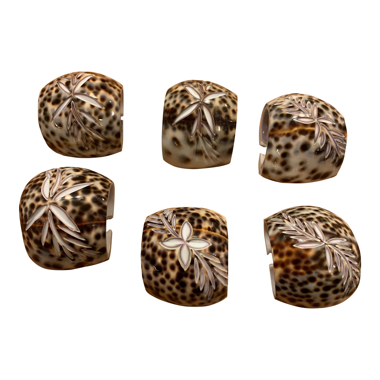 Late 20th Century Shell Napkin Rings Carved Cowrie Shells X 6: Hand carved cowrie sea shell napkin rings Set of six napkin rings Each napkin ring has a botanical carving on the top. Condition: Alterations: Original Condition Unaltered Imperfections: Some Imperfec
