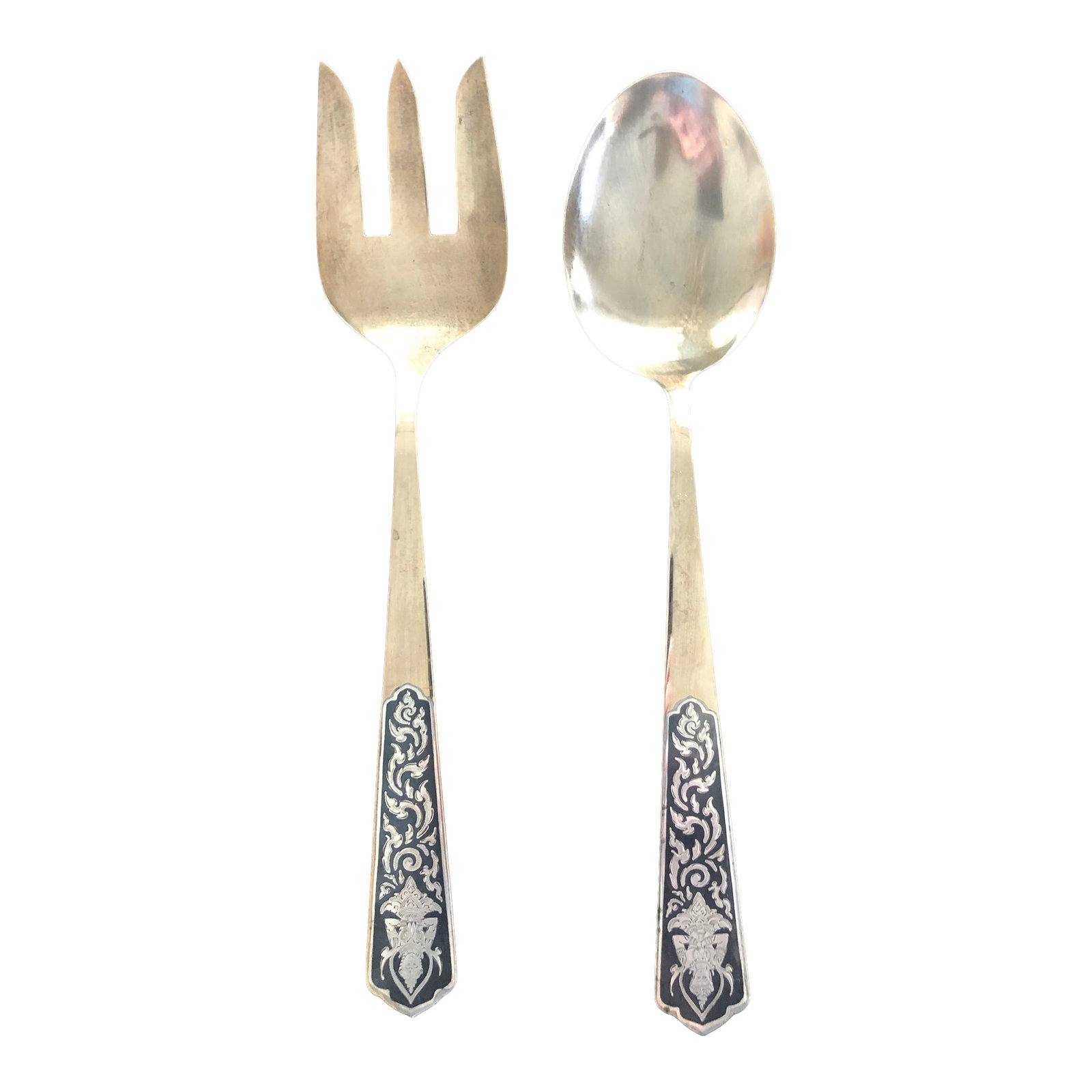 Vintage Siam Engraved Sterling Silver and Brass Serving Utensils Thailand: This lovely serving set is a vintage mid century export from Siam. Gods are featured in engraved sterling silver plates that are embedded into the solid brass spoon and fork. Good condition. Condition