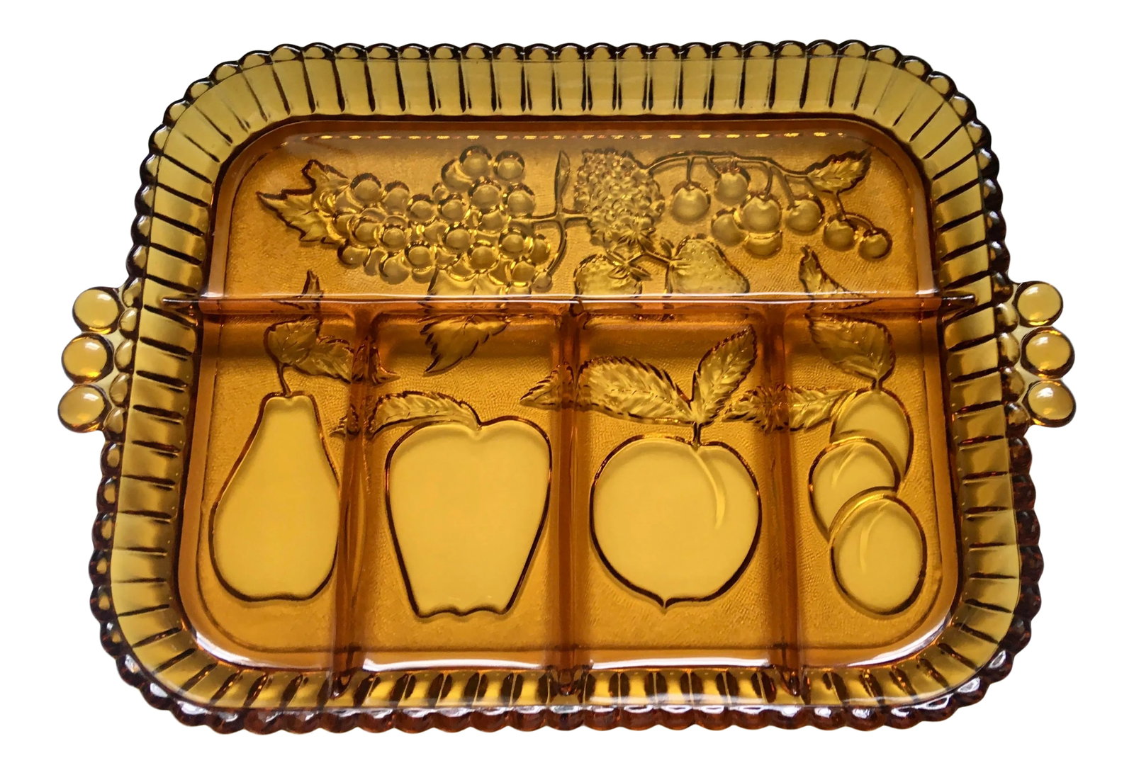 Mid-Century Indiana Amber Glass Sectioned Fruit Tray: A vintage amber glass serving tray divided into five sections with a fluted border and circular handles. Each section features a pressed glass fruit including apples, cherries, pears, grapes and peach