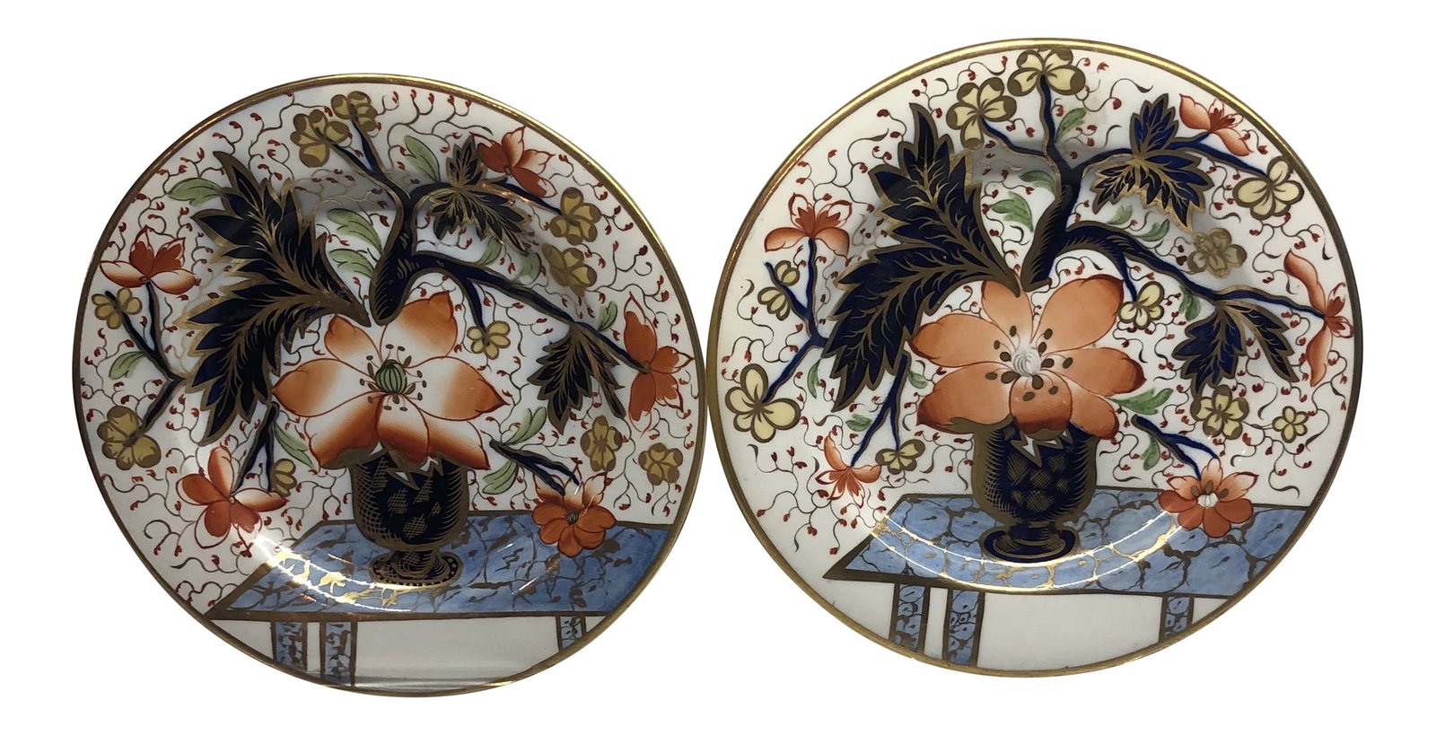 Antique Davenport Porcelain Plates- a Pair: Beautiful pair of antique English Davenport porcelain plates. Unusual hand painted stylised floral design in cobalt blue vase sitting on sky blue table. Plates are lavishly gilded with gold rims.