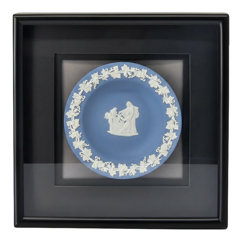 1970s Blue Wedgwood Jasperware Medallion Plate in Shadowbox Frame: This Wedgwood Jasperware wall piece features a classic pale blue medallion plate with creamy white relief of a neoclassical scene, framed in a deep black shadowbox for a clean, gallery-style