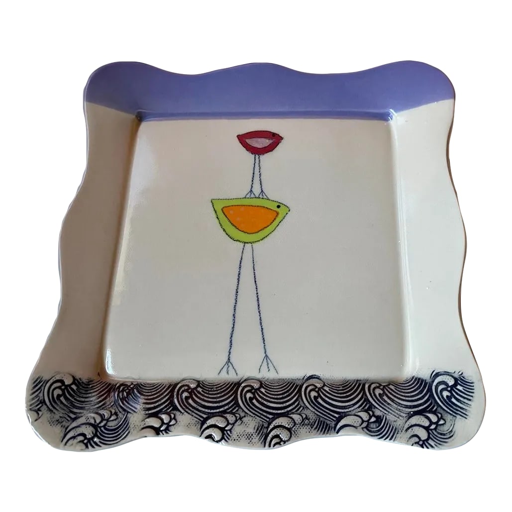 Whimsical Ceramic Bird Plate: Very cute plate. Primary colors are cream and lavender with a touch of orange and green. Wave pattern incised on the bottom of the plate. Charming scalloped edge. Maker unknown. . . purchased at the