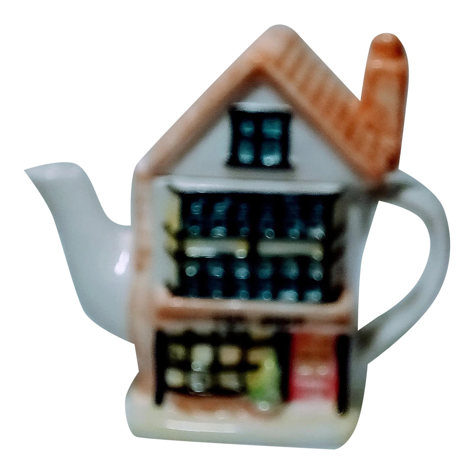 Vintage Ceramic Teapot: Charming two piece teapot made in China. It has shrubs, windows, and a sign that says Tea Shop. It measures roughly 6 1/2 x 7 x 3. There are a few paint drips on the inside that I believe came from
