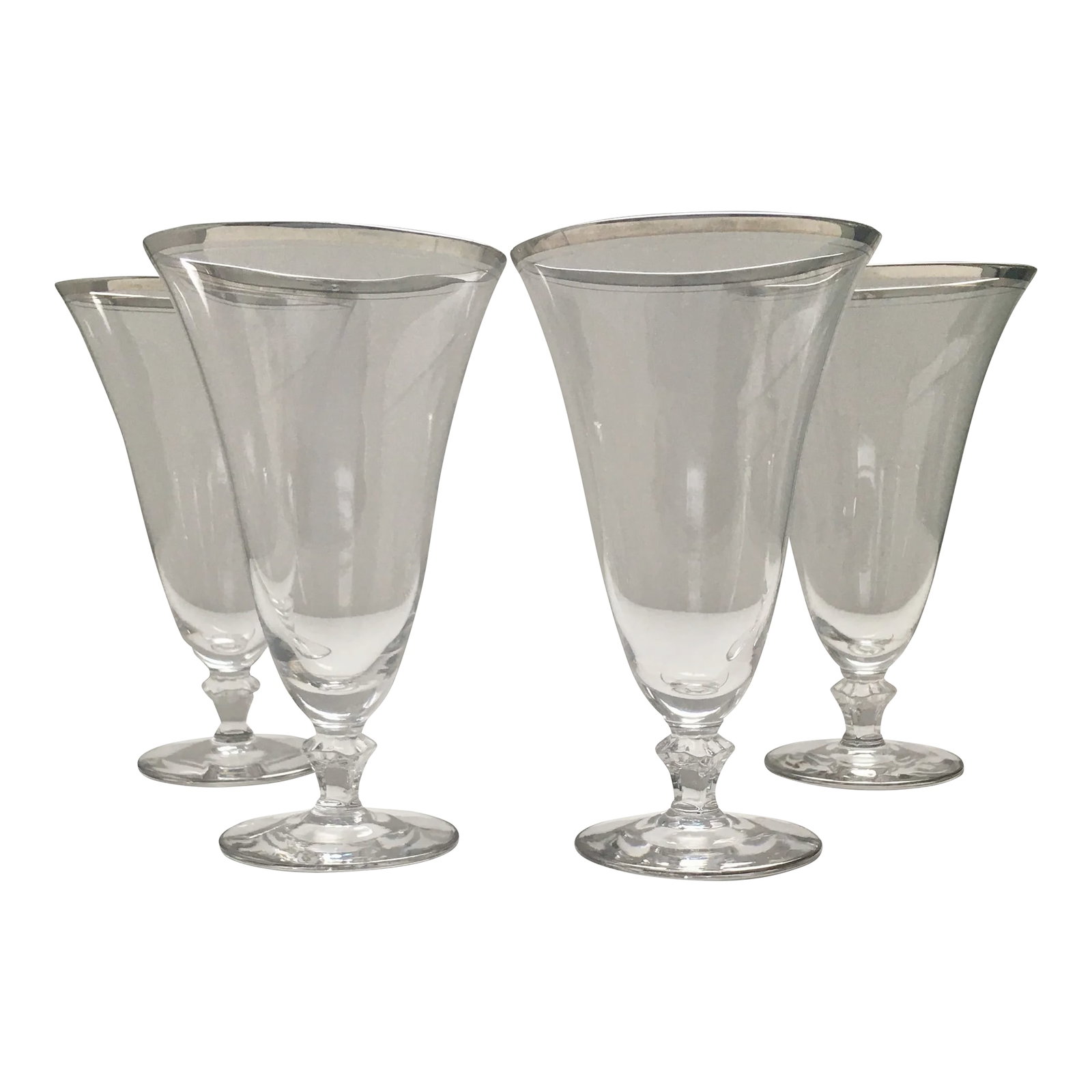1960s Platinum Rimmed Footed Water Glasses - Set of 4: This classic set of vintage water glasses has a tapered shape that is trimmed in silver on a round foot and adds an interesting touch to a table setting when paired with stemmed glasses. They are