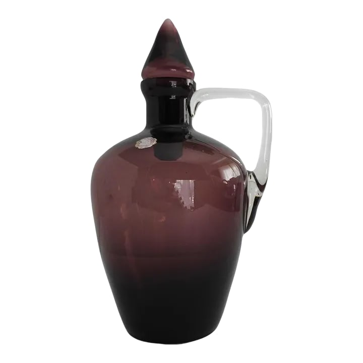 Amethyst Glass Jar Decanter With Handle Italy 1960s: Vintage amethyst glass wine jar, handle decanter with stopper. Made in Italy in 1960s. Clear square glass handle. 5"X4"X11"H. Excellent condition. Collectible glass. Postmodernist design. Condition: