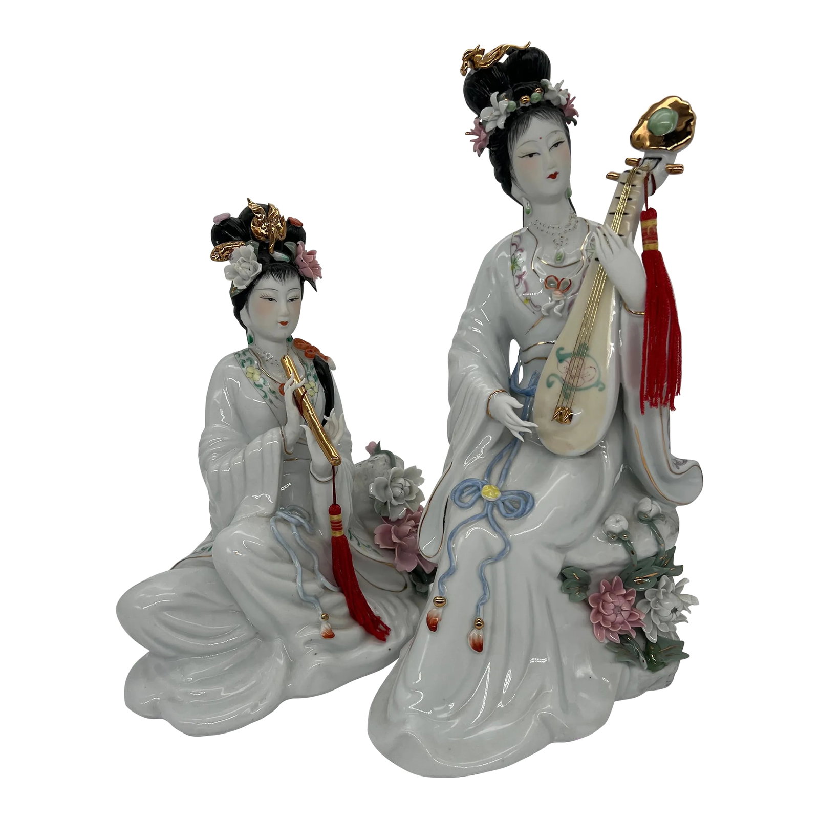 Vintage Asian Geisha Musician Figurines a Pair: Intricately designed Geishas playing musical instruments. Hand painted with gold accents. One lady is playing a lute and the other is playing a flute. Made of porcelain. These items are from a