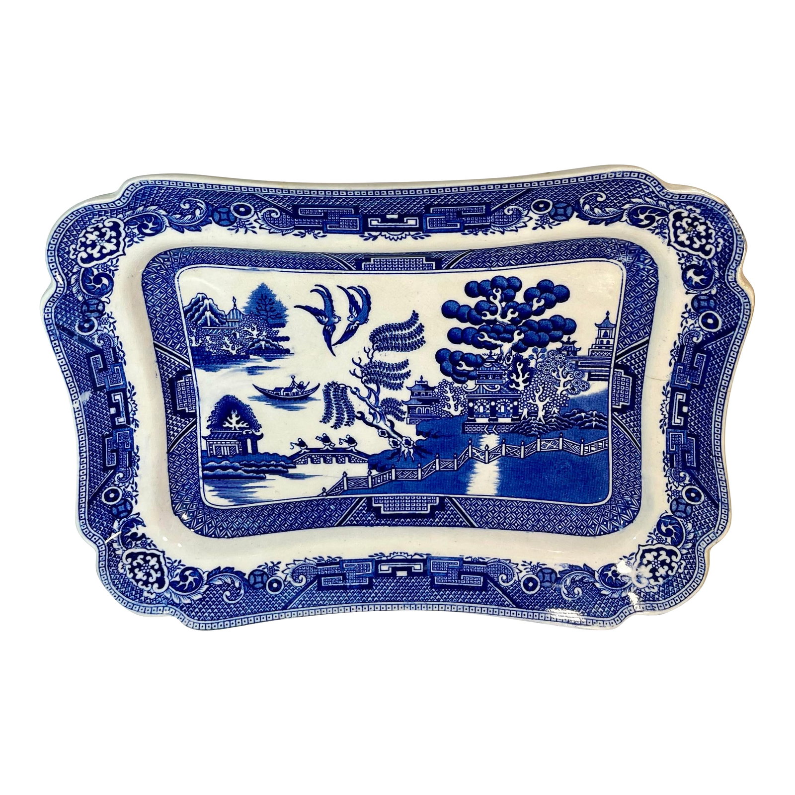 Early 20th Century Dudson, Wilcox, & Till Willow Blue Rectangular Serving Platter: Blue and white scalloped rectangular platter with a "Blue Willow" pattern. Features a pagoda, bridge, and willow trees.. Condition: Alterations: Original Condition Unaltered Imperfections: Some Imperf