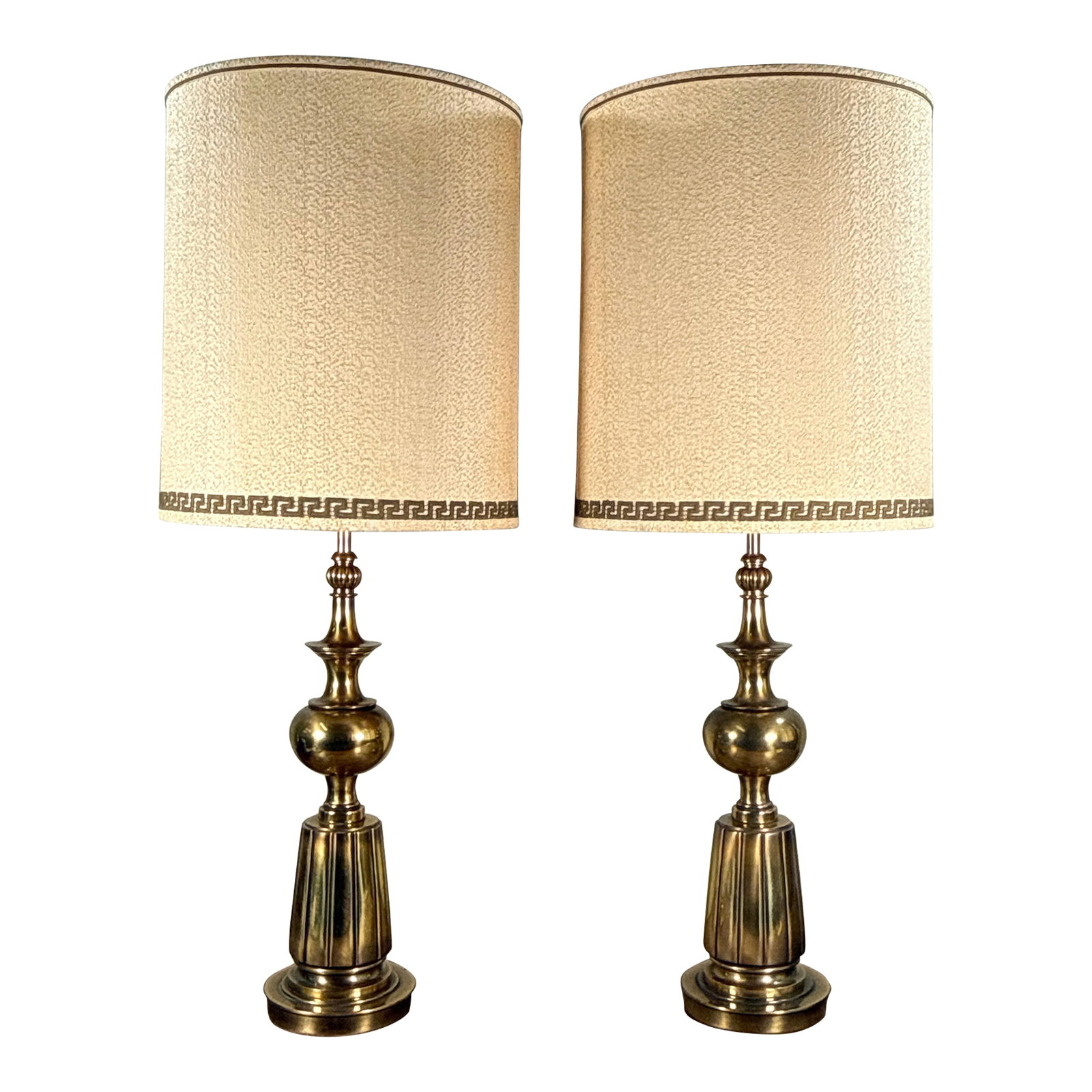 Stiffel Style Hollywood Regency Brass Table Lamps With Greek Key Shades - A Pair: This pair of Hollywood Regency style table lamps features brass bases with tiered baluster form stems including fluted column bases, spherical mid sections, and slim rods topped with decorative