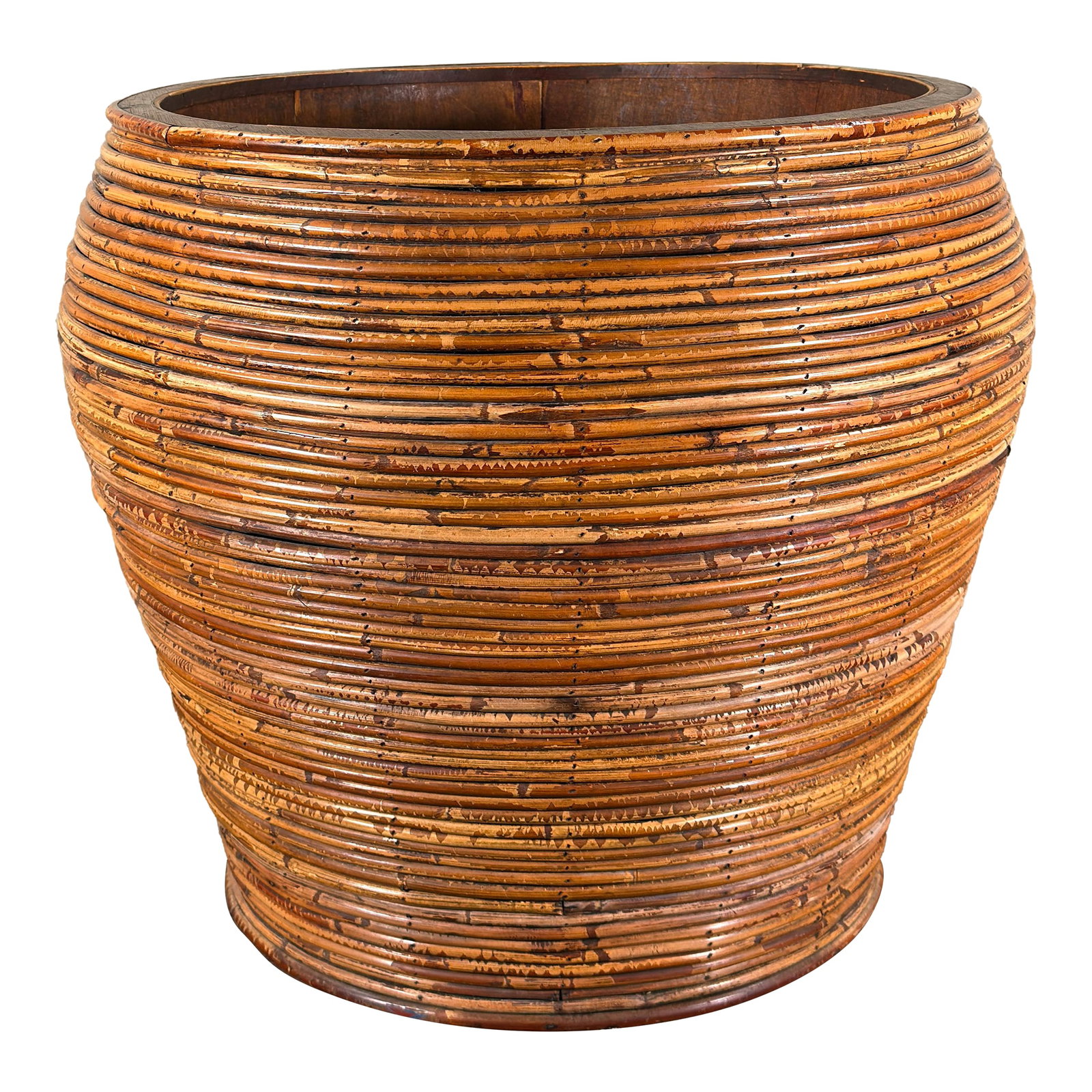 Large Vintage Pencil Reed Floor Planter Cache Pot: This oversized vintage planter features a tapered cylindrical form constructed from wrapped pencil reed / rattan coils over a wood frame. The exterior shows horizontal banding created by tightly wrapp