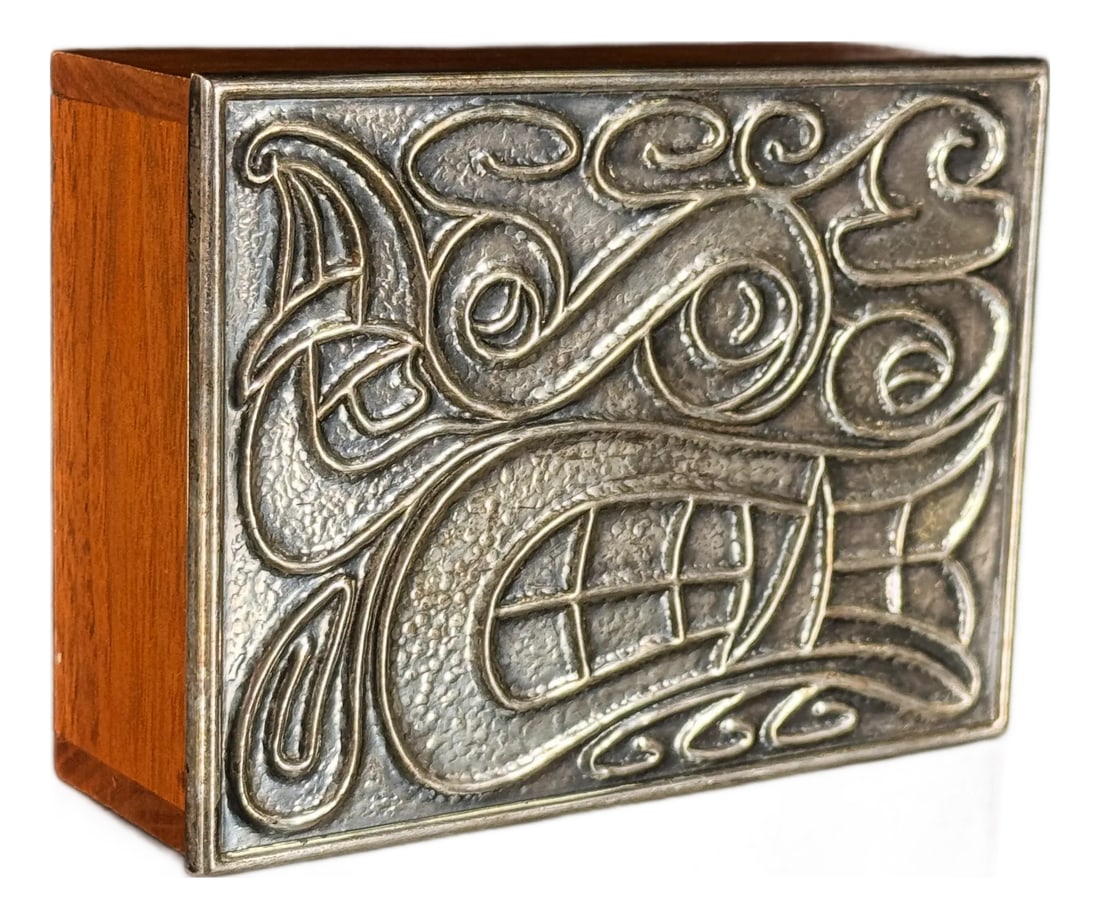 Vintage Napier Silverplate and Teak Lidded Box With Modernist Celtic Scroll Design, 1960s: This small desktop box by Napier pairs a warm solid teak body with a fitted silverplate lid cast in an interlocking scroll and knotwork design that draws from Celtic and Art Nouveau influences. The