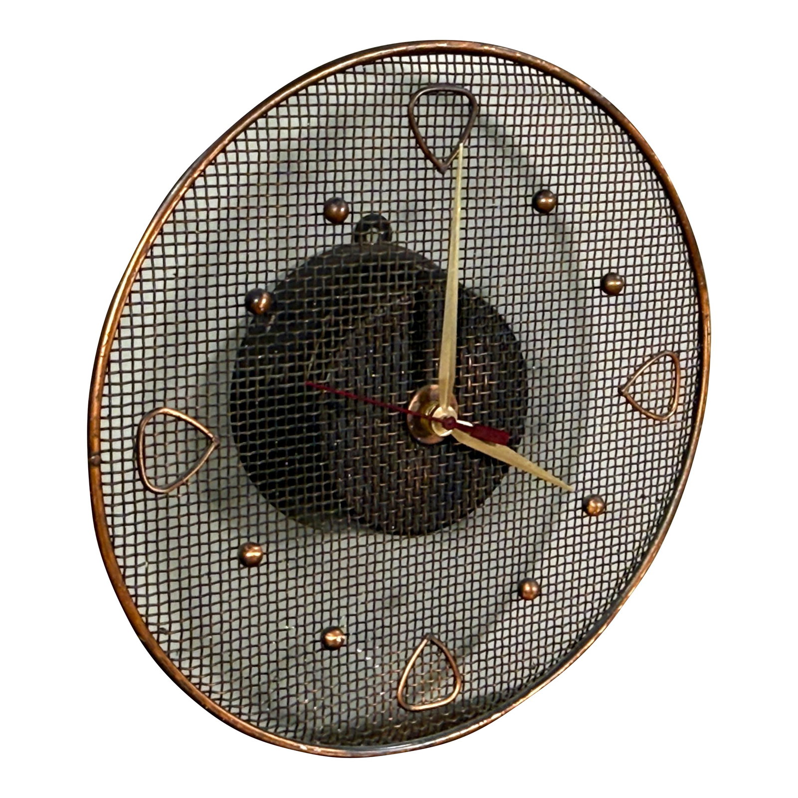 Mid Century Modern Copper Wire Mesh Wall Clock: This mid century modern wall clock features a circular copper wire mesh face with a woven mesh center section. The clock has applied copper spade shaped hour markers at 12, 3, 6, and 9 positions,