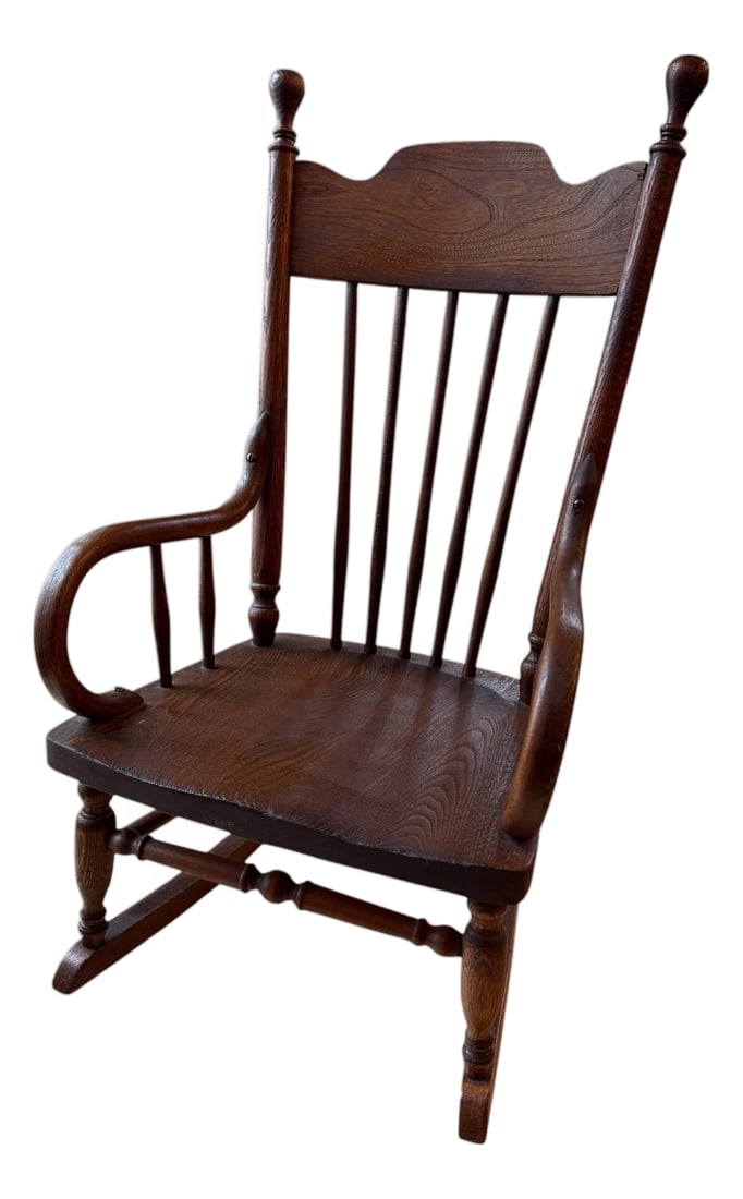 Antique Early American Oak Windsor Children's Rocker: Offering a patina-rich child's rocking chair, dating from the late 19th to early 20th century. Turn of the century spindle-back design with a decorative wavy crest rail. Features curved "bentwood" arm