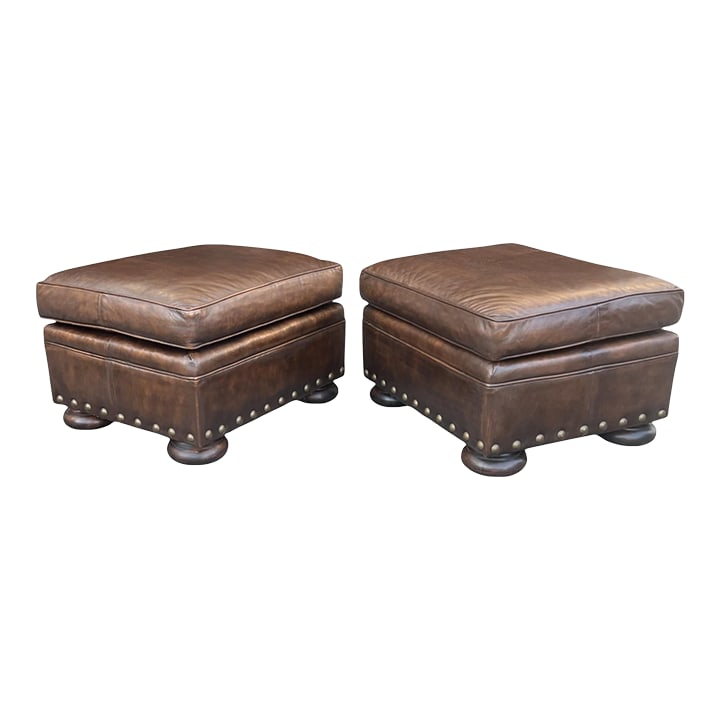 1960s Classic Pair of Brown Leather Ottomans With Brass Nailhead Trim: This refined pair of leather ottomans offers a timeless balance of comfort, craftsmanship, and understated elegance. Upholstered in rich brown leather, the surfaces have been thoughtfully conditioned 