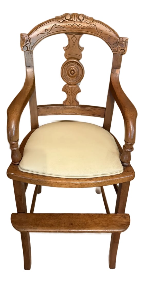 Antique Eastlake Victorian Style Carved Walnut Youth Chair: Antique Eastlake Victorian Style Carved Child's High Chair with a built in foot rest, original seat was caned apparent by base of chair & currently has a cream colored cushioned upholstered seat. Dime