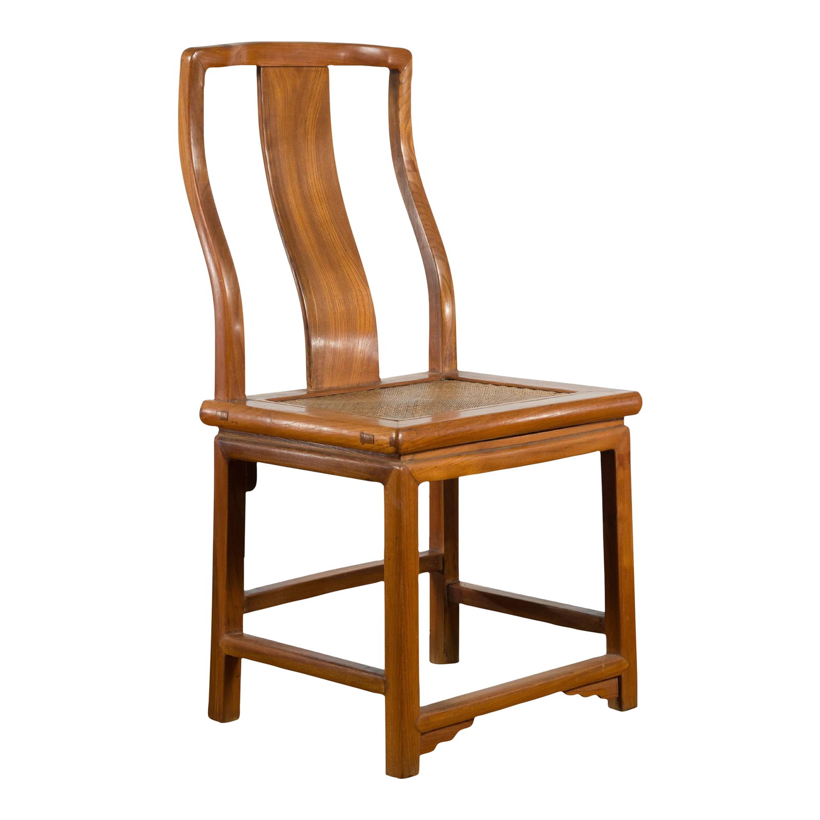 Early 20th Century Chinese Carved Elmwood & Rattan Seat Side Chair: A Chinese carved elmwood side chair from the early 20th century, with woven rattan seat. Created in China during the early years of the 20th century, this elm chair features a curving back with centra