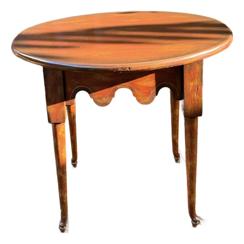 1990s Maitland-Smith Handcrafted Oval Side Table: This elegant oval side table by Maitland-Smith was handmade in the Philippines, showcasing the brand's reputation for finely crafted furniture. The scalloped apron with hand-painted gilt accents