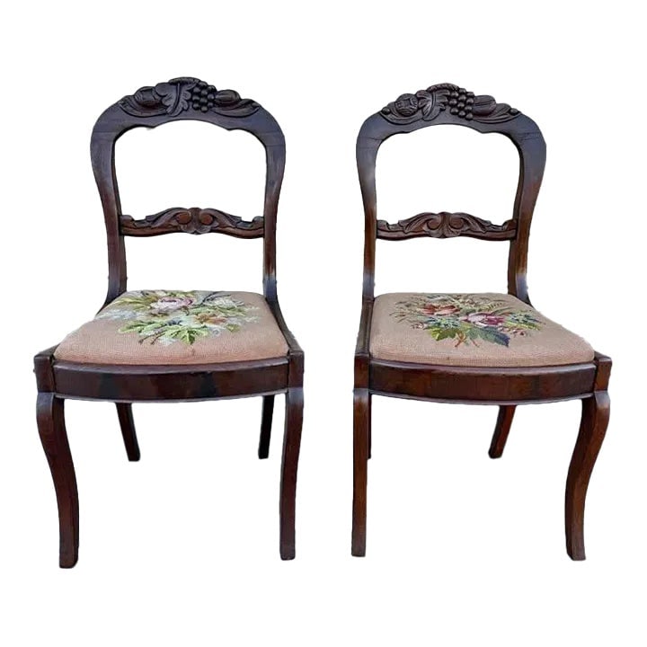 Early 20th Century Pair of Antique Victorian Style Walnut Balloon Back Carved Needlepoint Seat Side: Pair Of Antique Walnut Balloon Back Carved Needlepoint Seat Side Chairs. Sturdy and comfortable Needlepoint is useable as is Approximate measures: Height 35.1/2" depth 18" deep 18". Floor to Seat