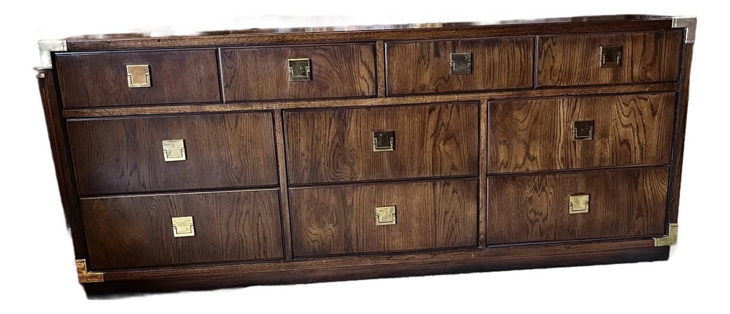 Late 20th Century Thomasville Campaign Style Dresser: Interesting and stylish campaign style dresser by Thomasville. Features eight spacious drawers with interesting brass hardware and straight simple lines of campaign form. Good vintage condition with